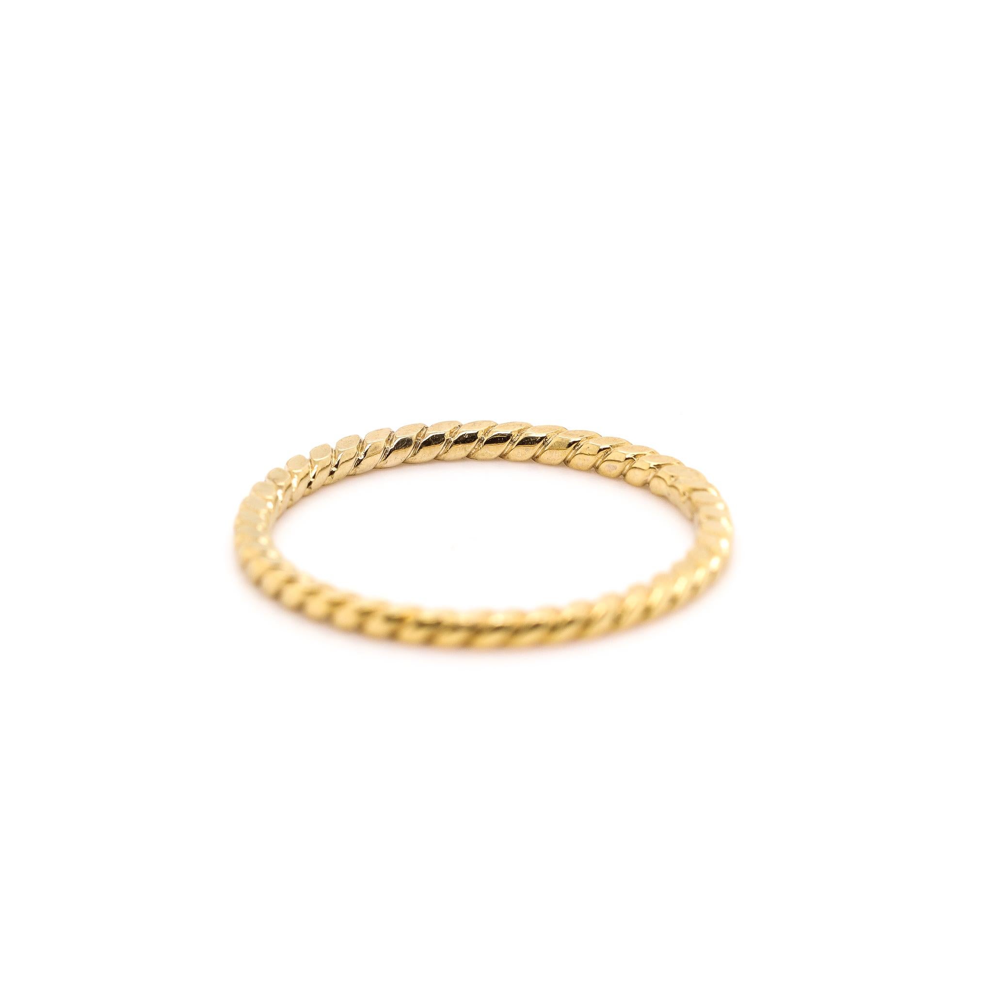 One lady's custom made textured & polished 14K yellow gold, trinity ring with a half round shank. The ring is a size 6.25. The ring weighs a total of 1.10 grams. In excellent condition.

SKU: 133705