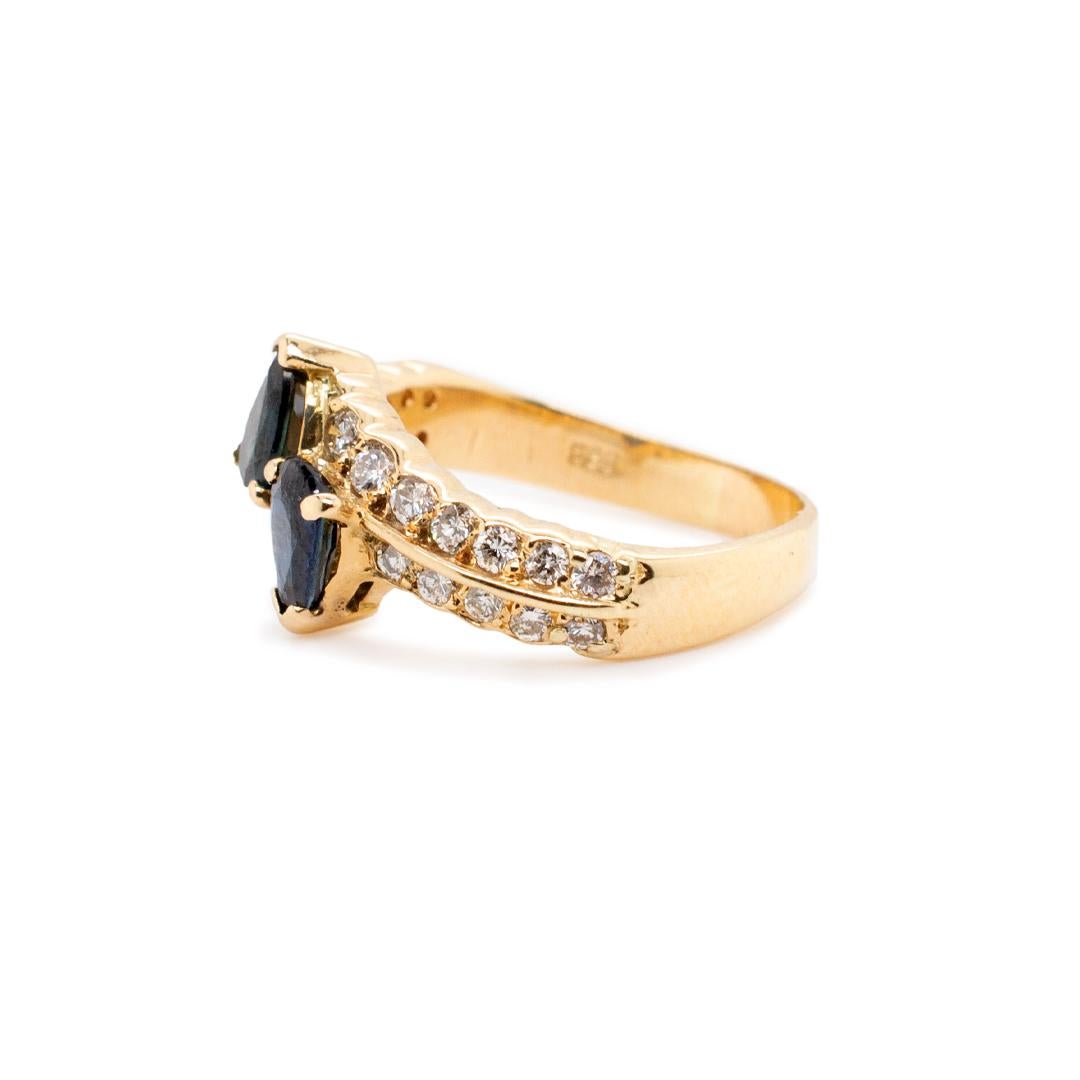 One lady's custom made polished 14K yellow gold two-stone, diamond and sapphire cocktail ring with a soft-square shank. The ring is a size 5. The ring weighs a total of 3.70 grams. Engraved with 
