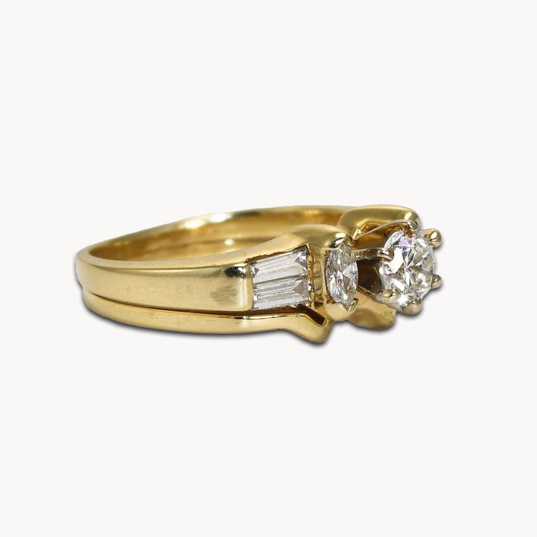 Diamond ring set in 14k yellow gold. 
The center diamond is a round brilliant cut, .40 carats, i to j color, si2 clarity, good cut.
On the sides are two marquise shape diamonds and 4 baguettes, .50 total carats, h to i color, vs clarity.
Attached to