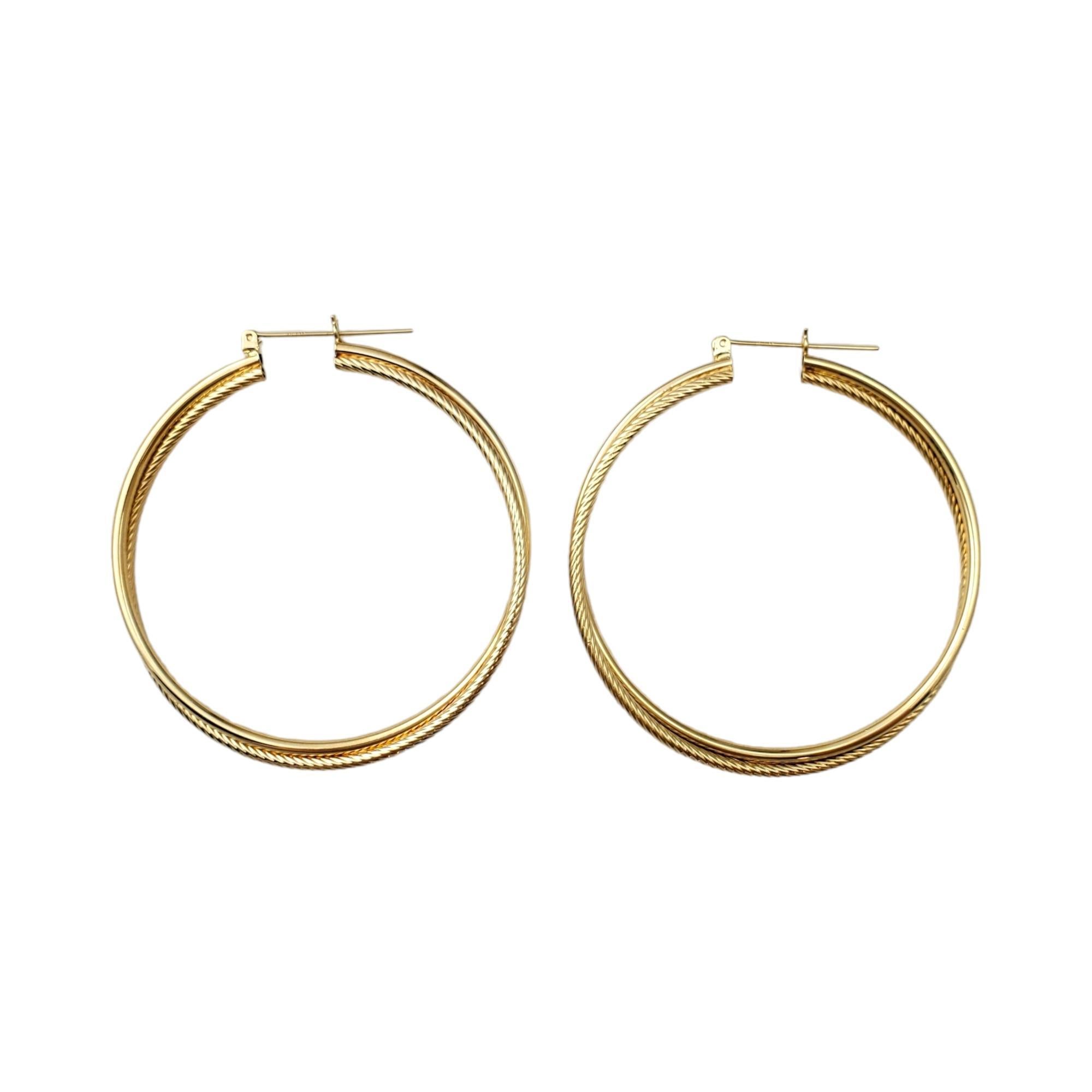 14K Yellow Gold Large Crossover Hoop Earrings -

These classic hoop earrings make a statement and are a gorgeous addition to your collection. 

One loop is smooth gold and one loop is set in a cable design.

Hang approx. 2 1/4