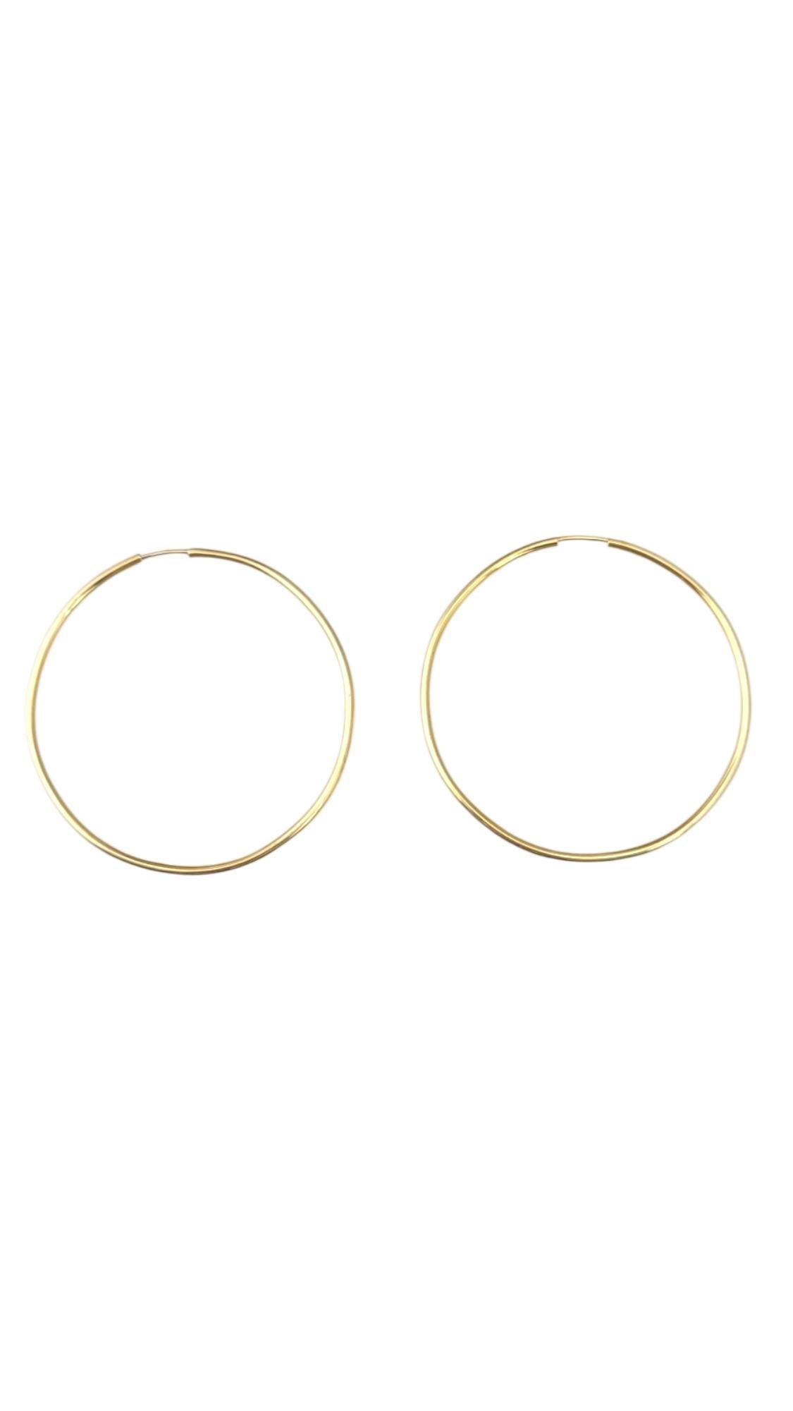 14K Yellow Gold Large Hoop Earrings -

These classic hoop earrings offer a timeless design that effortlessly complements any style. Crafted for versatility, they are perfect for both everyday wear and special occasions, adding a touch of elegance