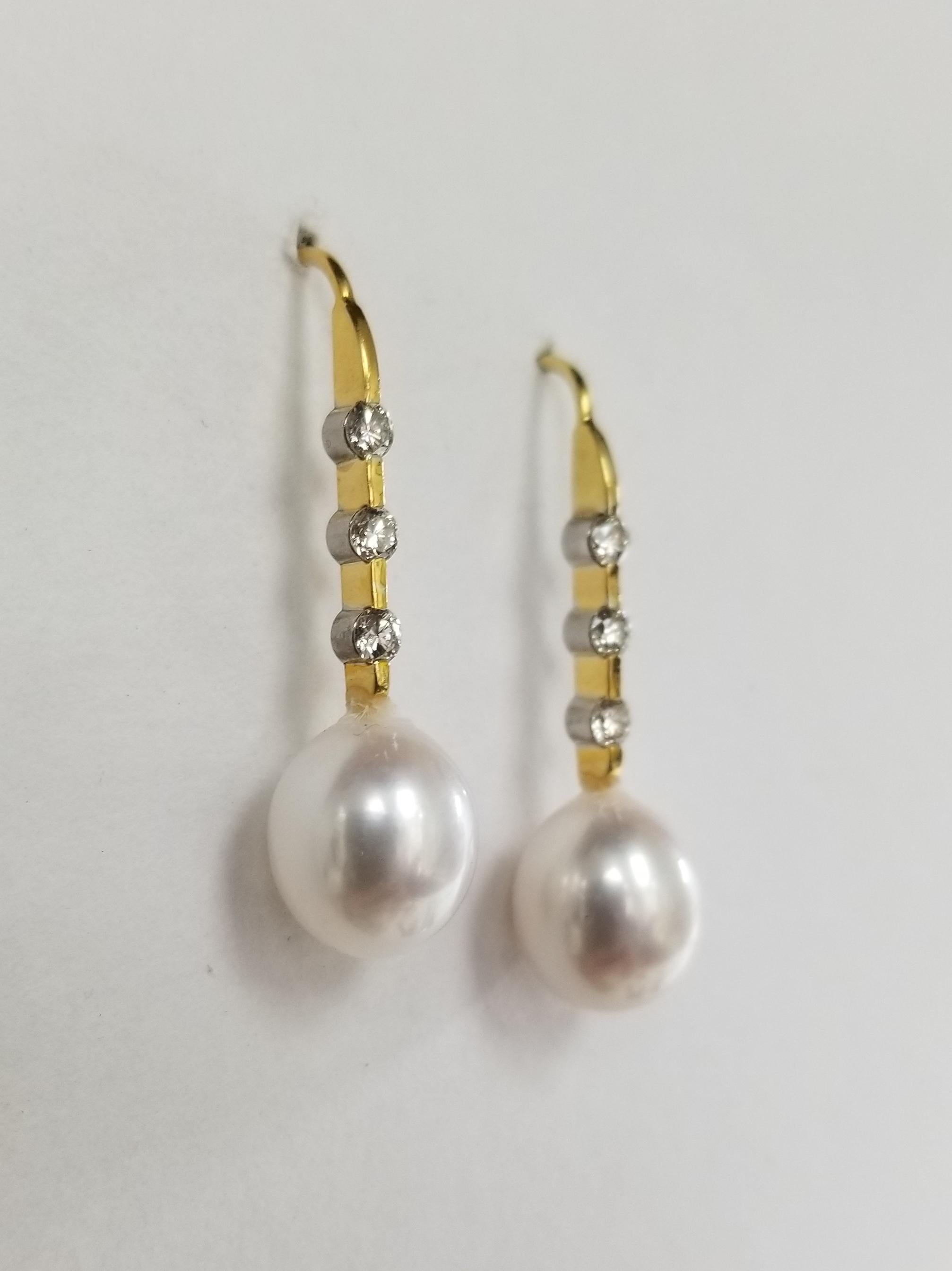 14k yellow gold large pearl and diamond drop earrings, containing 2 fresh water pearls 10mm x 12mm with round full cut bezel set diamonds weighing .36pt.s