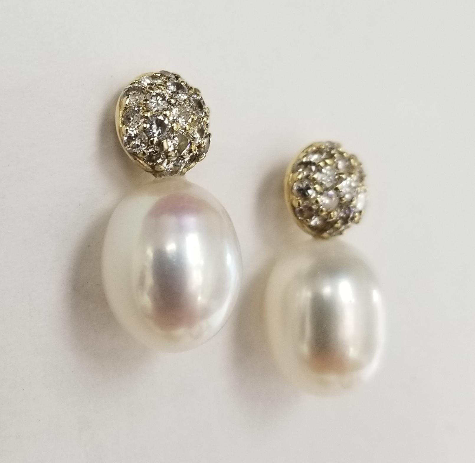 14k yellow gold large pearl and diamond drop earrings, containing 2 fresh water pearls 10mm x 12mm with round full cut pave set 38 diamonds weighing 1.06pt.s
