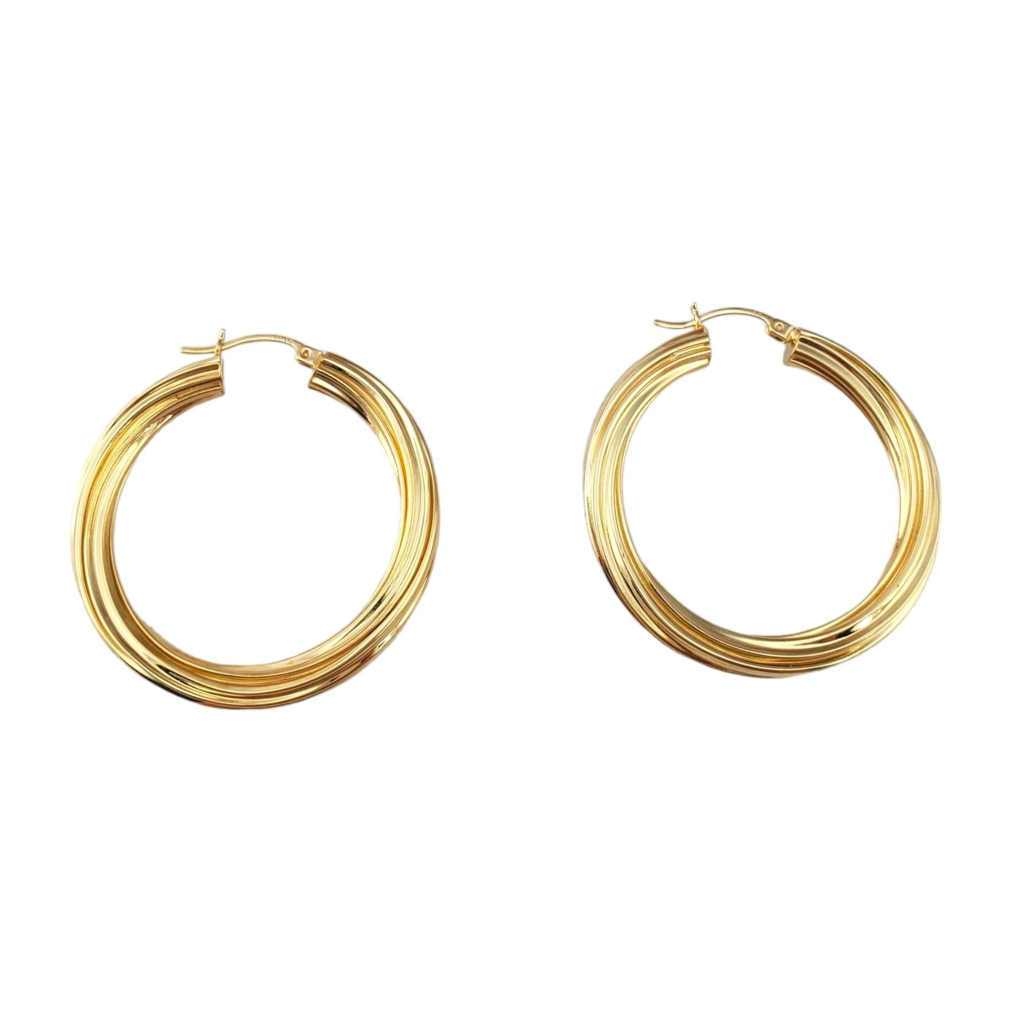 14K Yellow Gold Twist Hoops 

Crafted from luxurious 14K yellow gold, these hoops feature a striking twisted design that adds a unique and sophisticated flair.

Hallmark: B8 14K

Weight: 7.0 g/ 4.5 dwt.

Thickness: 4.9 mm

Diameter: 41 mm

Very good