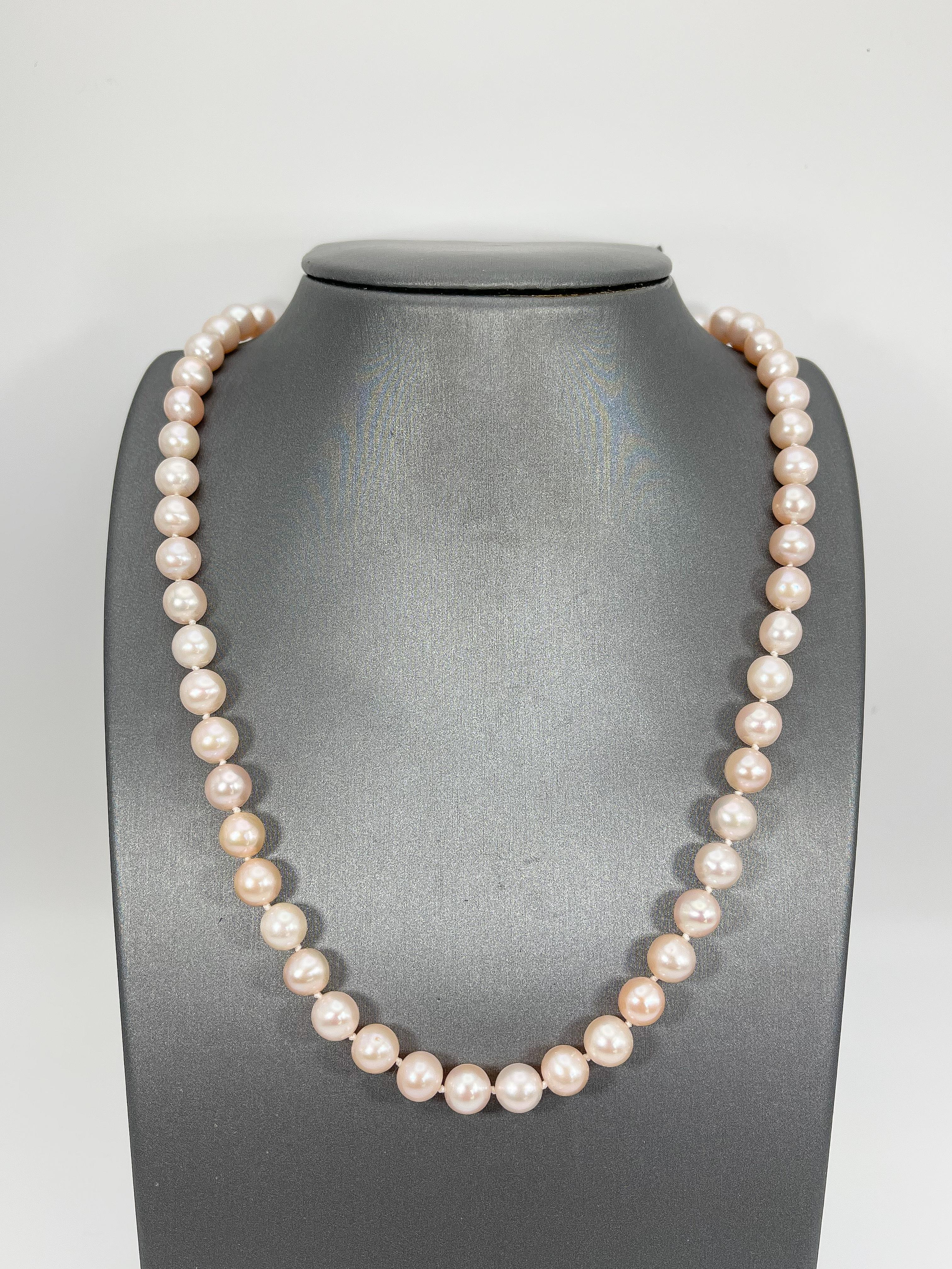 14k yellow gold light pink pearl necklace. This necklace  is 19 inches, the width is 7-7.75 mm, has a pearl clasp to open and close, and it has a total weight of 36.46 grams.