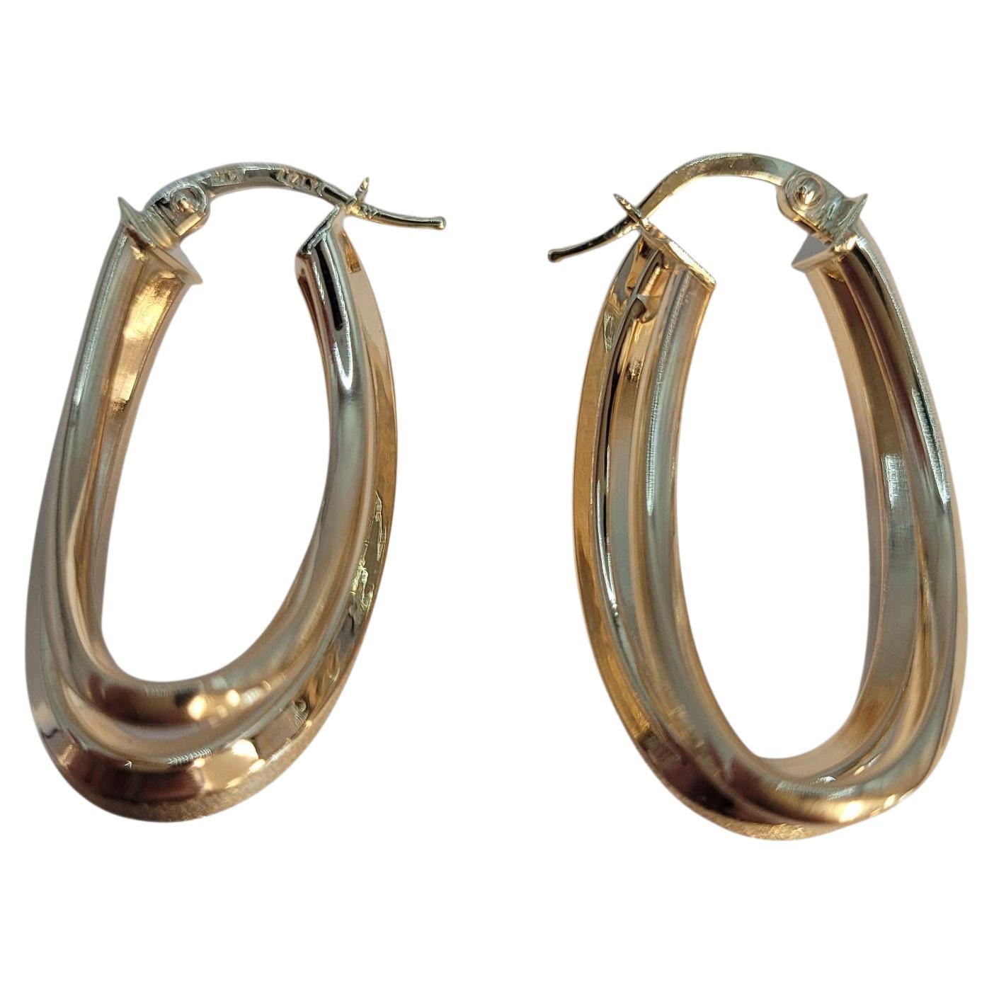 Boucles d
oreilles double ovale en or jaune 14k légèrement texturé #23145