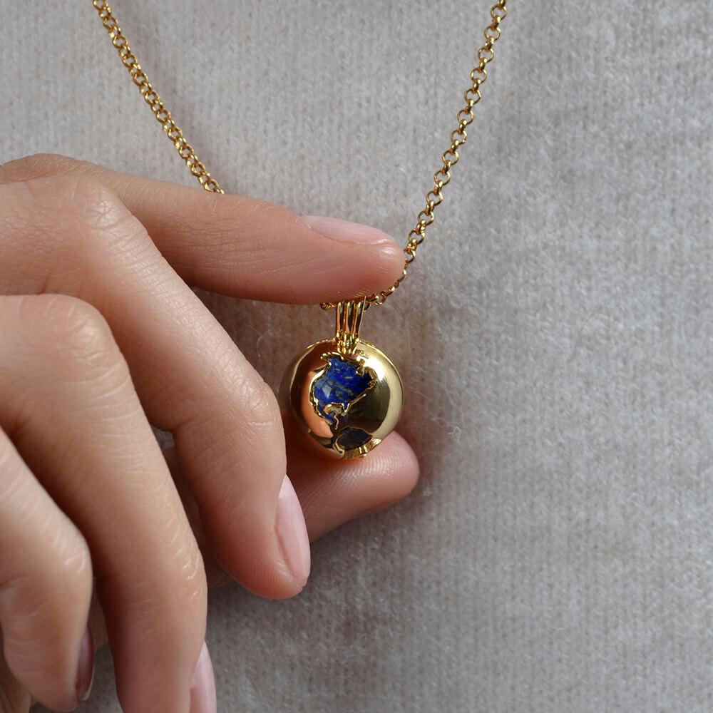 This beautiful one of a kind 14k yellow gold locket includes one round 10mm Lapis Lazuli gemstone.

With an intricate design that illustrates all the countries of the world and encapsulates the essence of all the precious gifts the Earth has for us,
