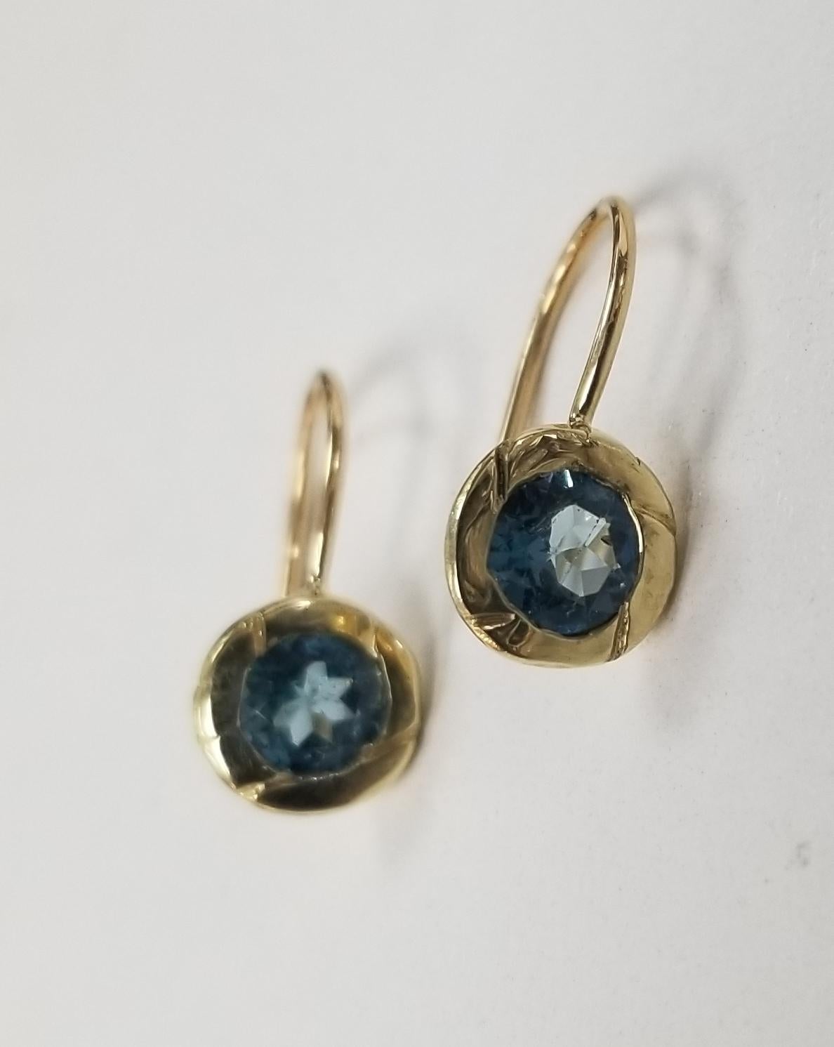 14k yellow gold London blue topaz bezel set earrings, containing 2 round London blue topaz.