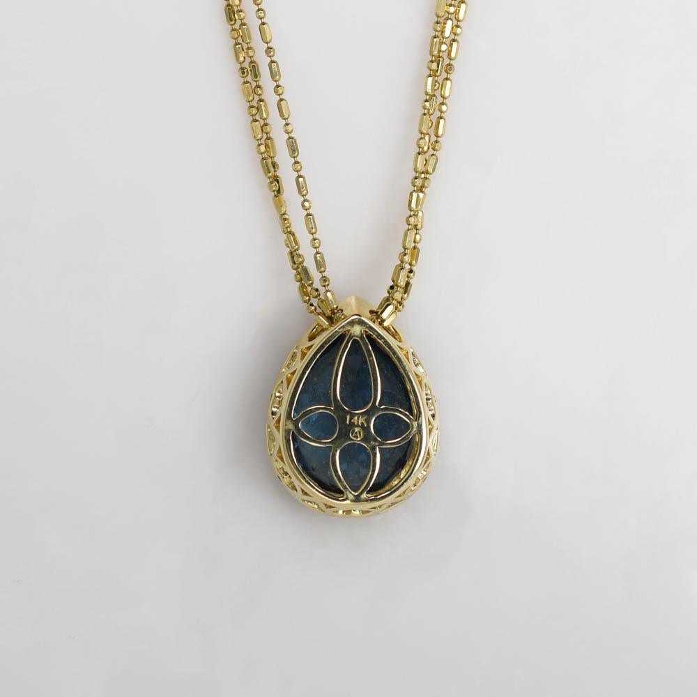 Ladies 14k yellow gold necklace with custom made London blue topaz and diamond pendant.
Stamped 14k and weighs 10.1 grams.
The topaz is pear shaped, 10 carats, deep blue color.
On the sides are round brilliant cuts., .18 total carats, g,h,i color