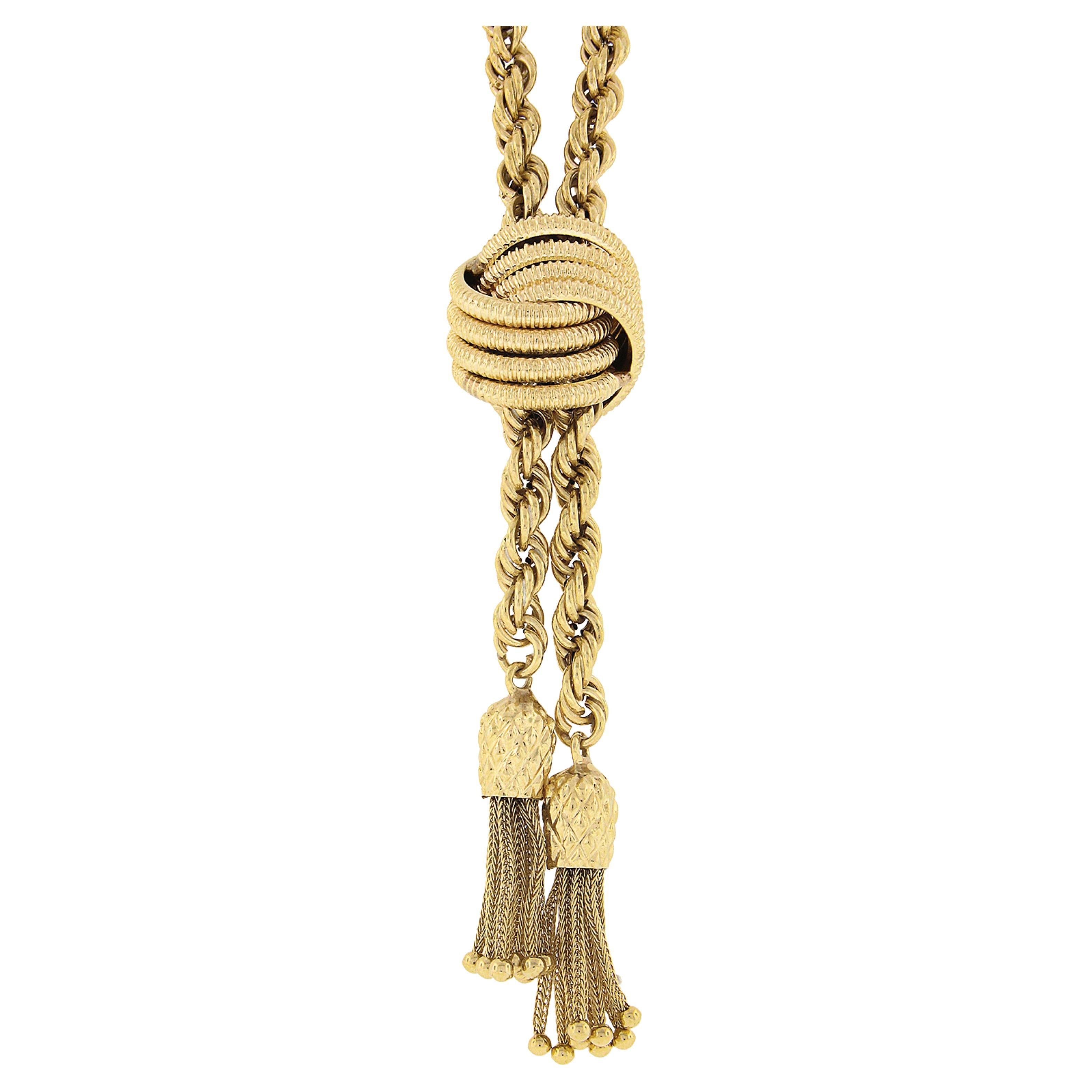 You are looking at a gorgeous necklace with a sliding pendant that was crafted from solid 14k yellow gold. The necklace features a long and fancy 5.7mm rope link chain with tassels that gently dangle from the bottom, as well as a pendant that