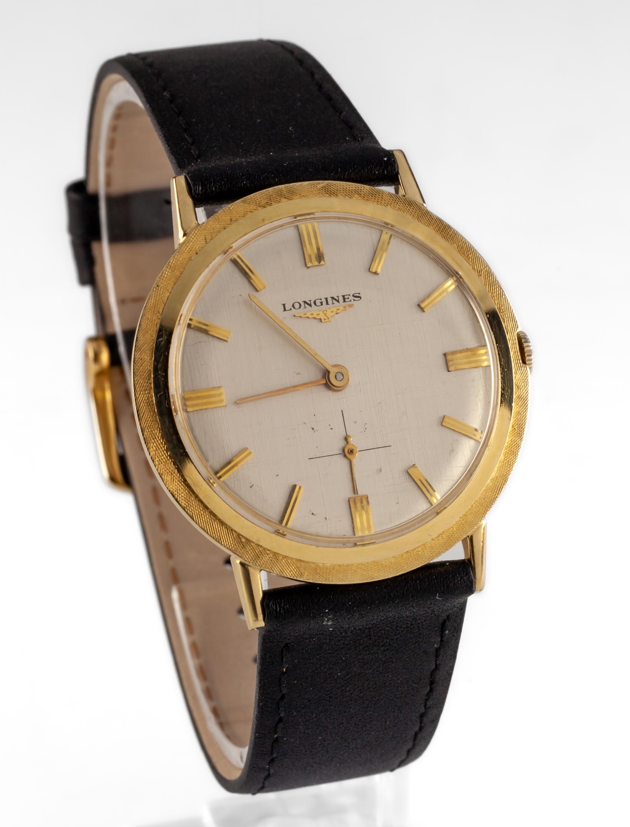 14k Yellow Gold Longines Mens Hand-Winding Watch w/ Leather Band 23.Z
Movement #23.Z
Case #710937.179
14k Yellow Gold Round Case
34 mm in Diameter (35 mm w/ Crown)
Lug-to-Lug Distance = 38 mm
Lug-to-Lug Width = 18 mm
Thickness = 7 mm
Silver Textured