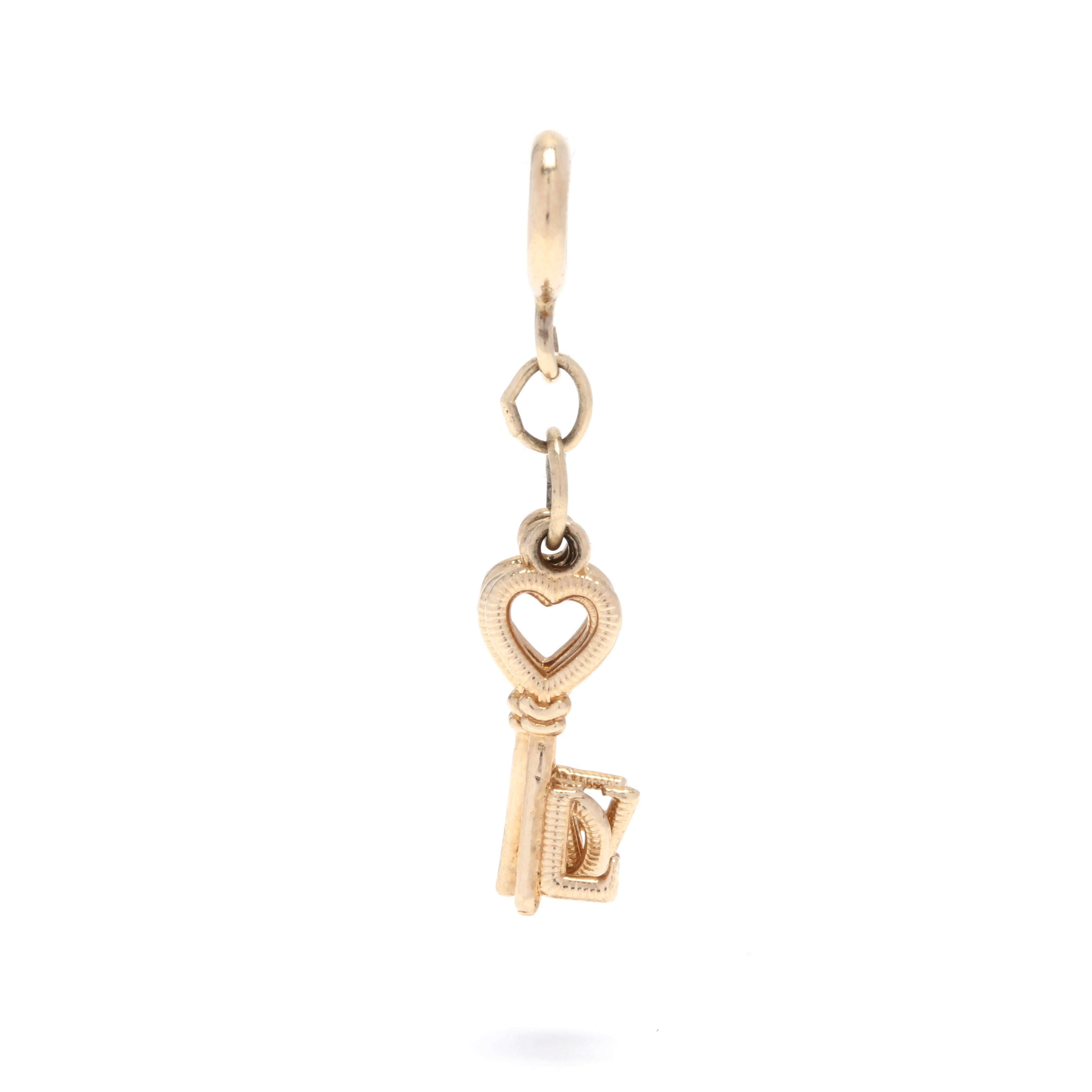 A 14 karat yellow gold 'LOVE' keys charm / pendant. This pendant features four key motifs with hearts at each top and a letter at each bottom that spells out the word LOVE and a spring ring clasp.

Length: 1 1/8 in.

.62 dwts.

* Please note that