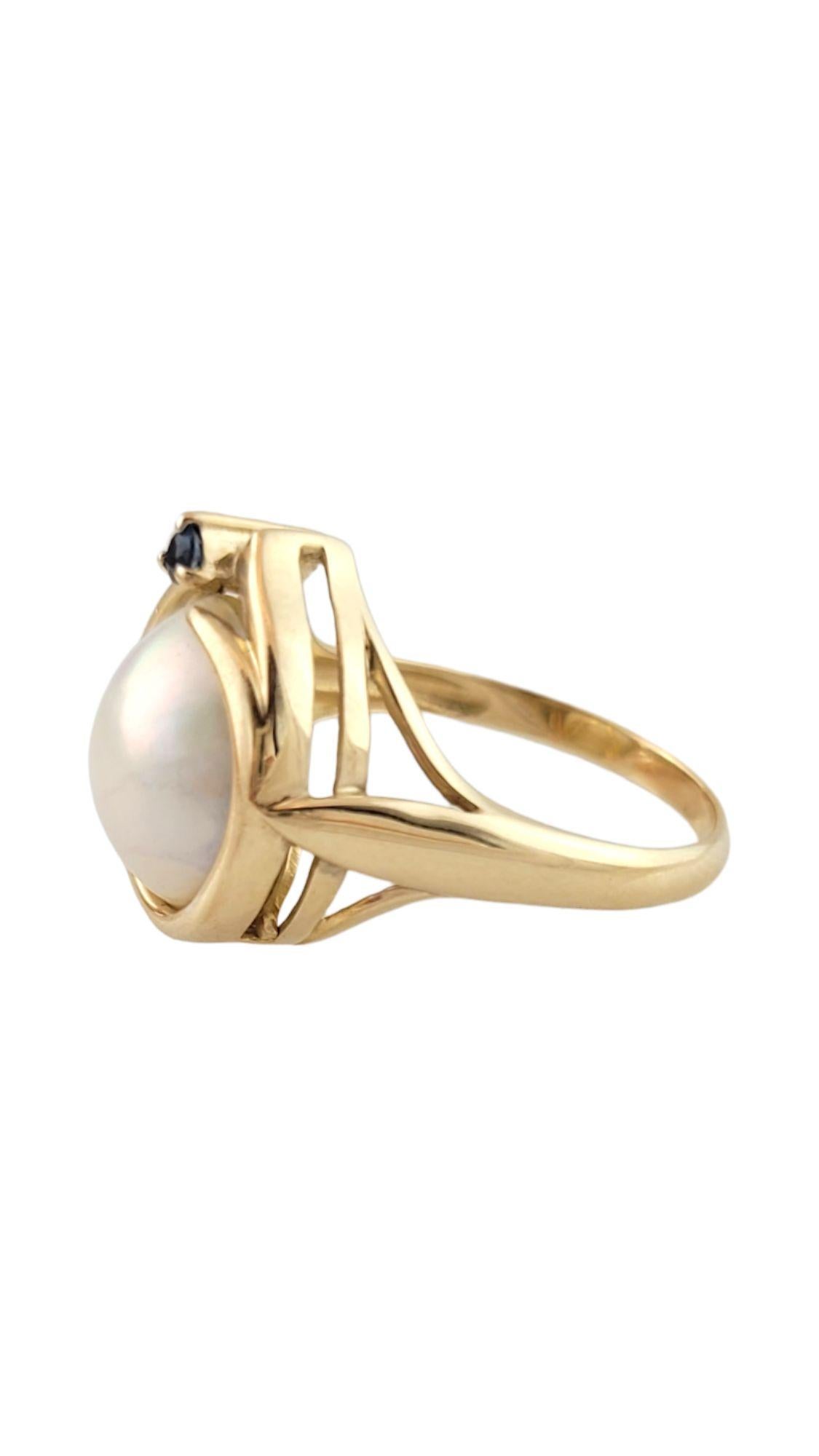 This gorgeous 14K gold ring is decorated with a beautiful Mabe pearl and a sparkling blue sapphire for a bold and beautiful look!

Pearl: 11.9mm

Ring size: 8.5

Shank: 2mm

Front: 16.4mm X 14.7mm X 8mm

Weight: 4.15 g/ 2.7 dwt

Hallmark: 14K

Very
