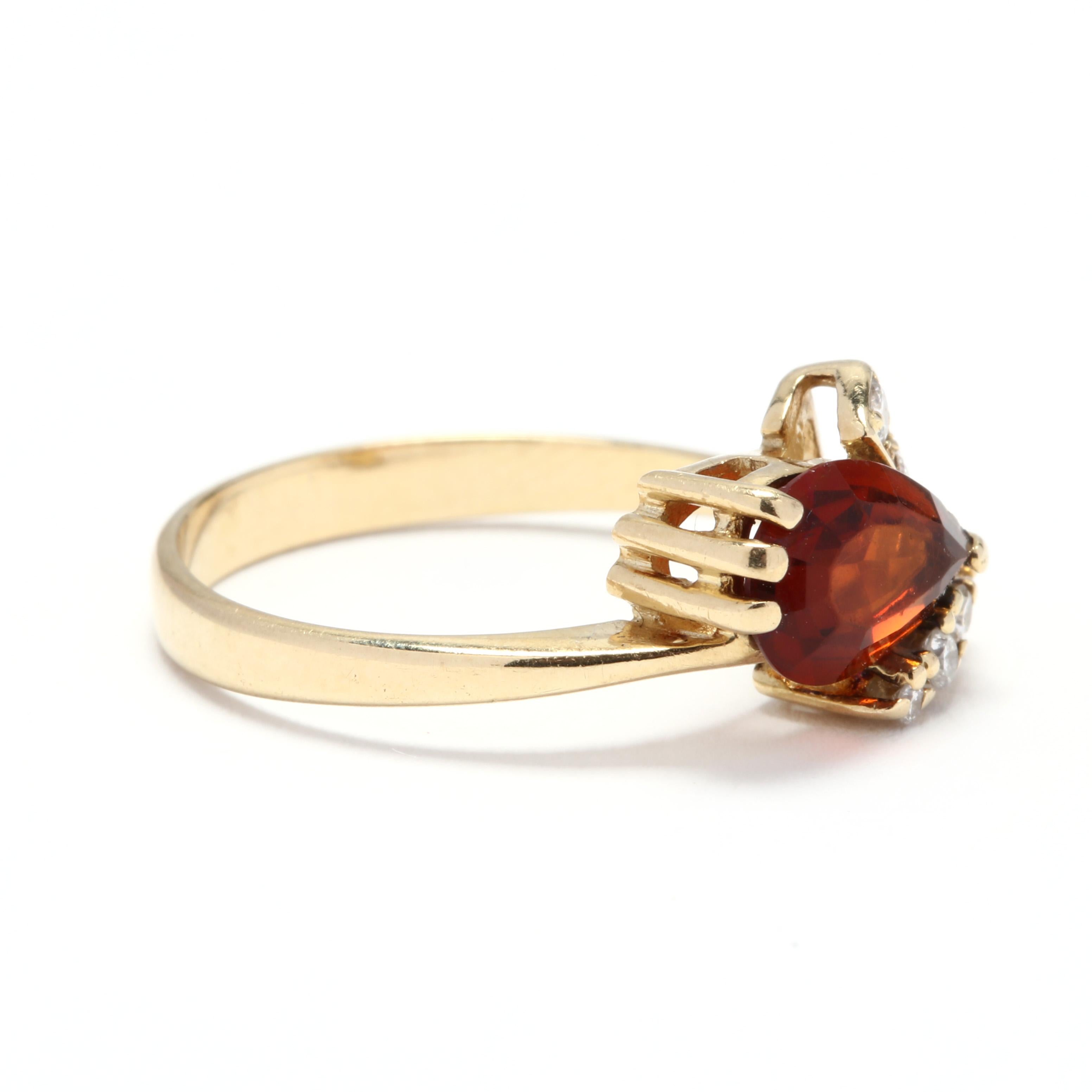 A 14 karat yellow gold, madeira citrine and diamond ring. This ring features a horizontal, prong set pear shape madeira citrine with a V shape detail set with full cut round diamonds weighing approximately .11 total carats and a thin