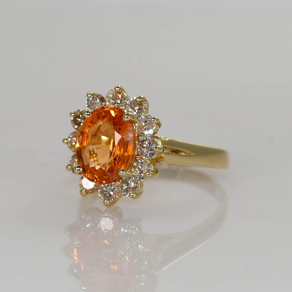 Ladies mandarin garnet and diamond ring in 14k yellow gold setting.
Stamped 14k and weighs 5.9 grams gross weight.
The mandarin orange garnet is a bright orange, oval shape, 3.70 carats.
On the sides are round brilliant cut diamonds, 1.00 total