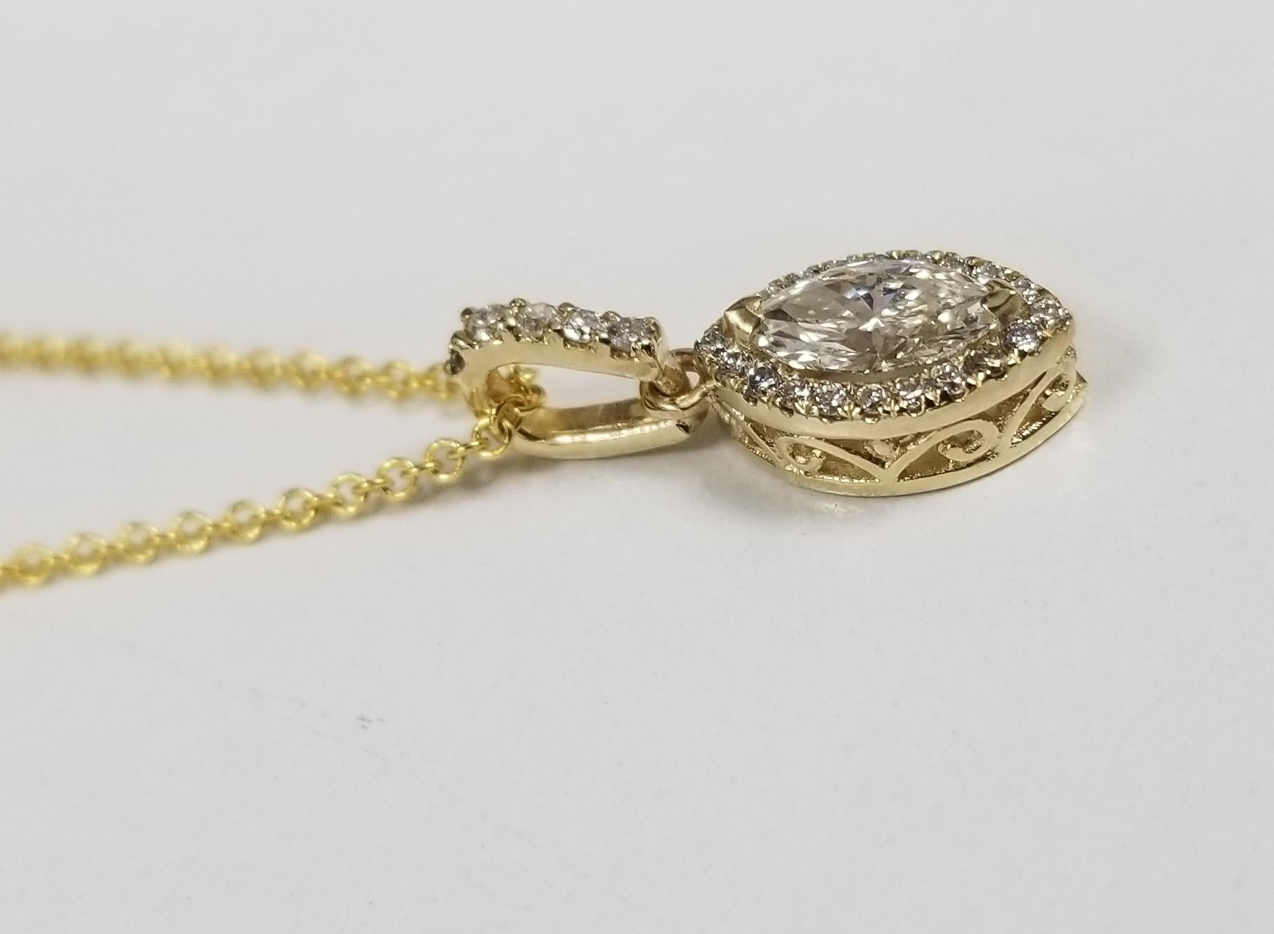 14k yellow gold marquise and diamond halo pendant, containing 1 marquise cut diamond; color 