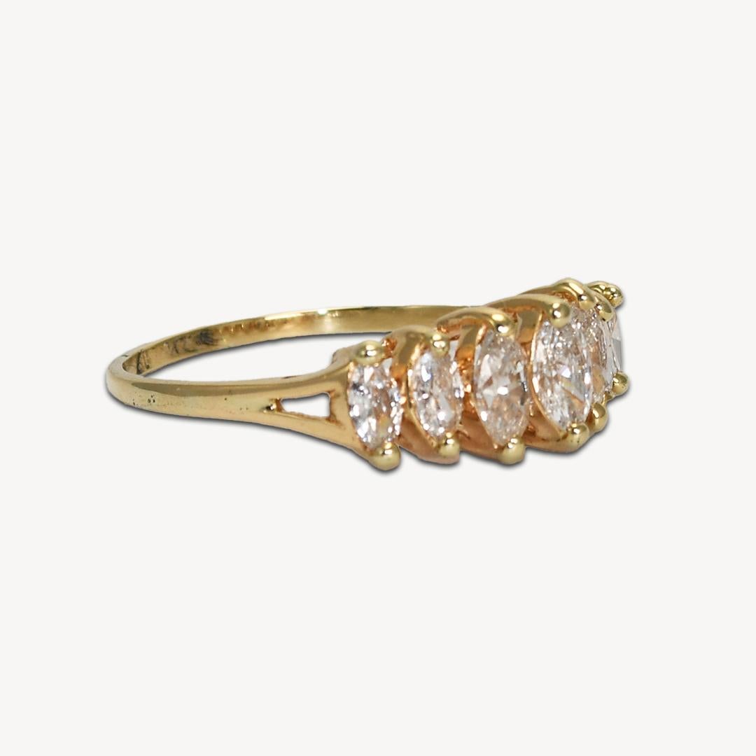 Diamond ring with marquise shaped diamonds set in 14k yellow gold.
Tests 14k and weighs 2.5 grams.
There are seven marquise shaped diamonds, 1.00 total carats, F to G color, VS to SI clarity, very good cuts.
The ring size is 8 1/2 and can be