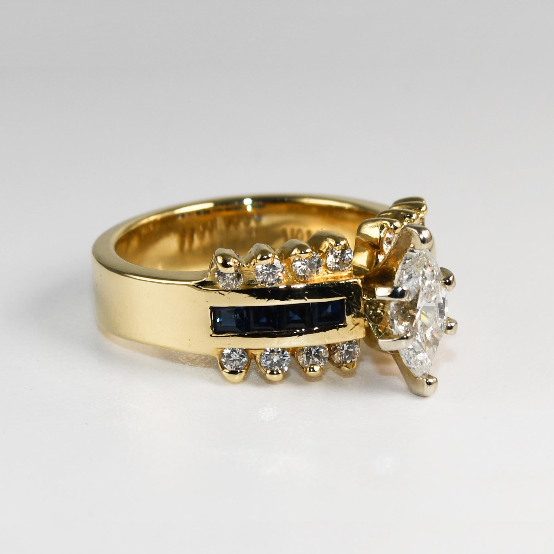 14k yellow gold and marquise diamond engagement ring.
Stamped 14k and weighs 7.9 grams gross weight.
The center diamond is marquise shape, .65 carats, H to I color, i1 clarity.
The side diamonds are round brilliants, i color, Si clarity, .30 total