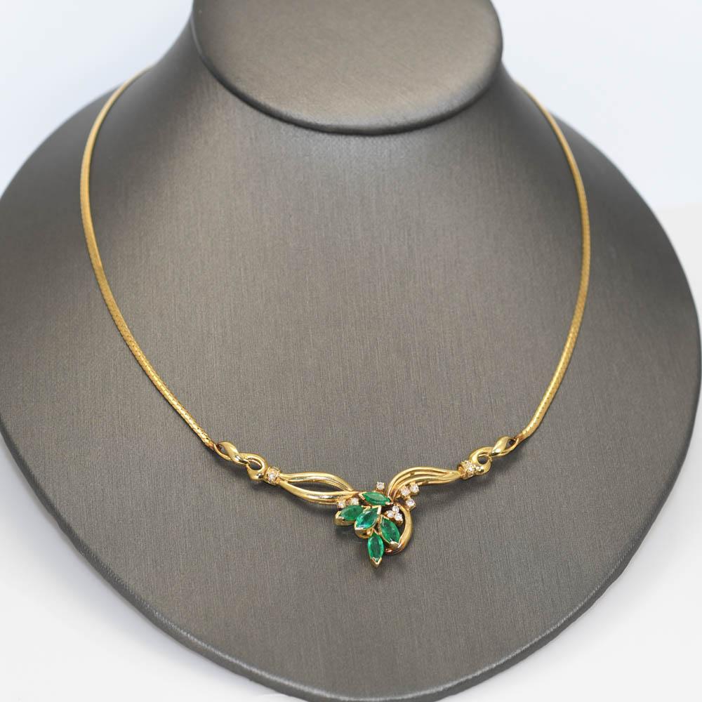 Set with 5 Marquise cut natural Emeralds and .01-.02ct diamonds .20tdw.
Very elegant design.
The chain is thin Herringbone style that is 2mm.
16in long. 
tests and stamped 14k