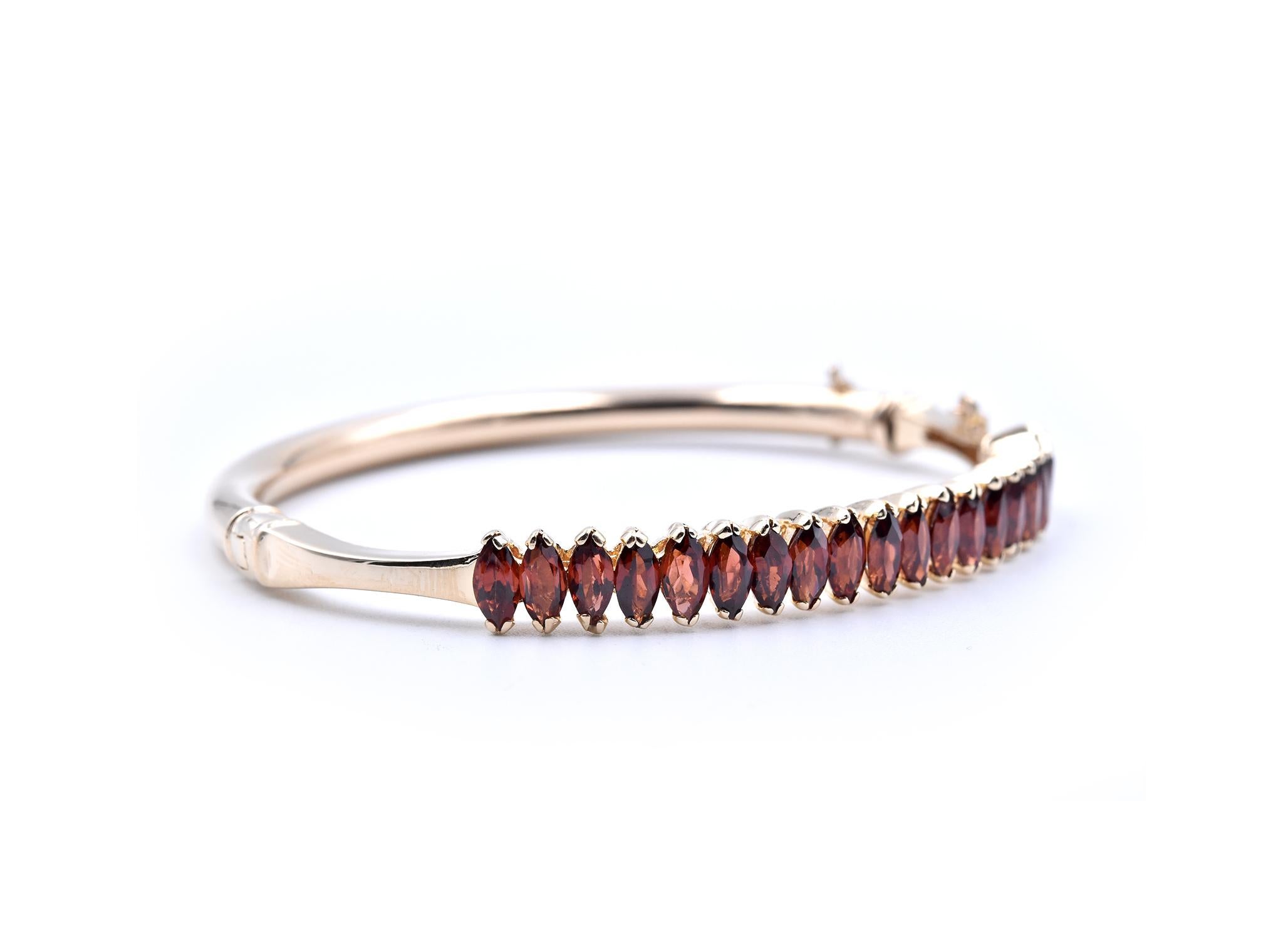 Designer: custom design
Material: 14k yellow gold
Garnets: 20 marquise cut garnets
Dimensions: bracelet will fit a 6.5-inch wrist and it measures 6.85mm wide
Weight: 17.38 grams

