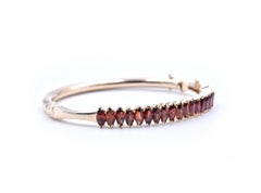 14 Karat Yellow Gold Marquise Garnet Hinged Bangle Bracelet