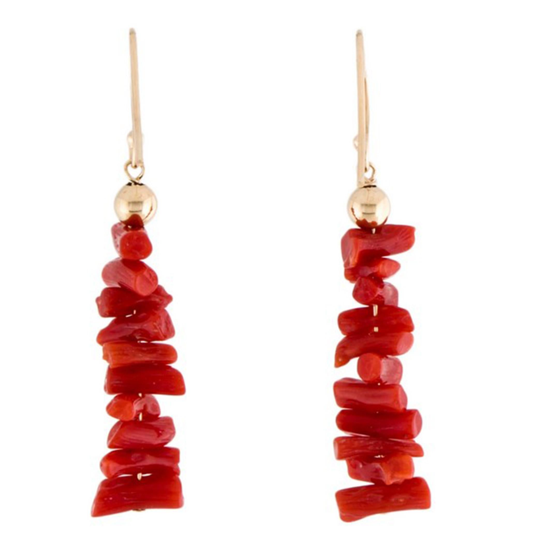 These earrings feature a stunning natural cayenne coral color earrings that dangles from a delicate 14k gold hook. The shape of the corals are sticks a very modern touch to them. The cayenne coral is a natural stone that is known for its vibrant