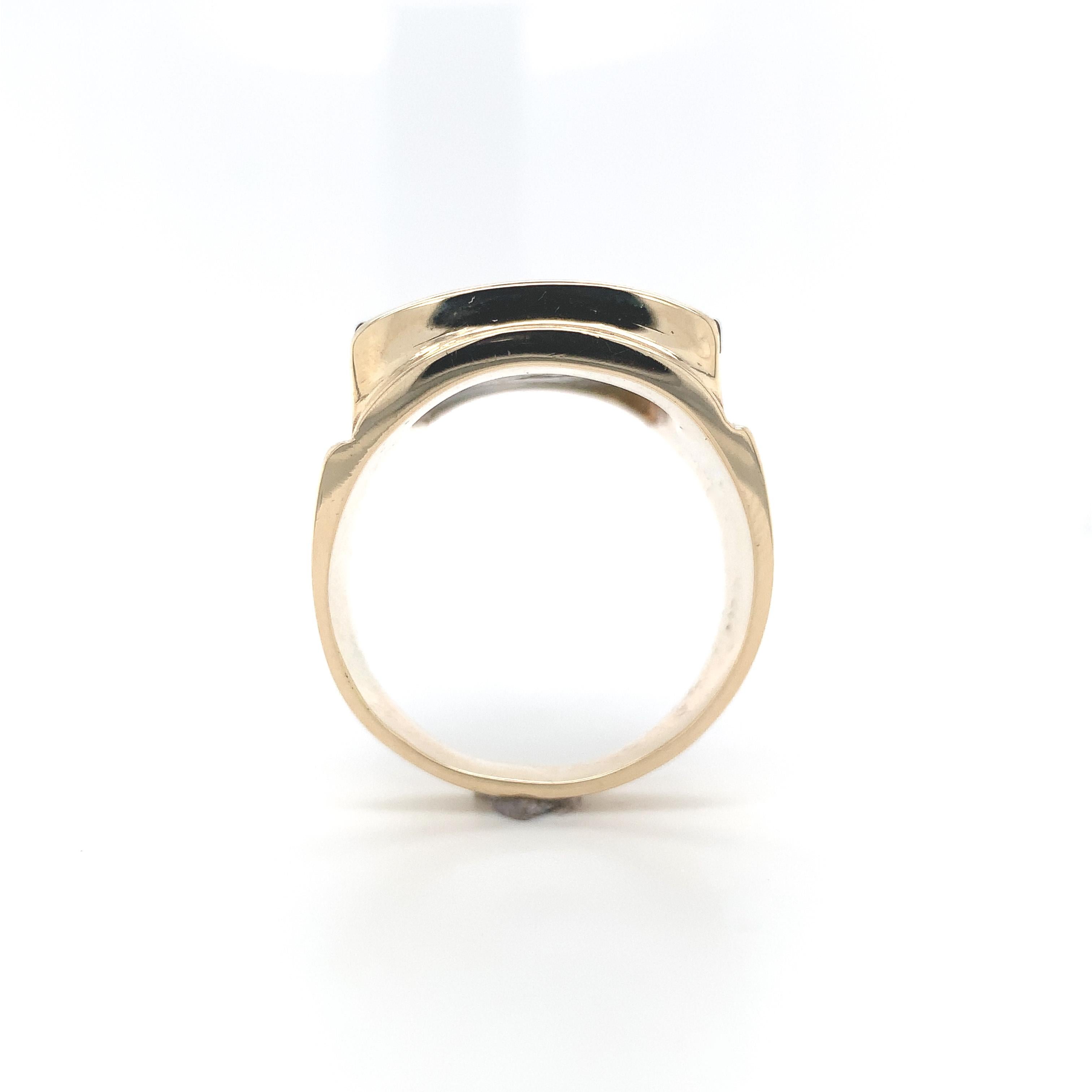 Men's 14K yellow gold black onyx and eagle ring. The flat slab rectangular black onyx measures about 20mm x 14mm. There is an applied yellow gold eagle with spread wings. There is resin behind the stone which adds to the weight of the piece. The
