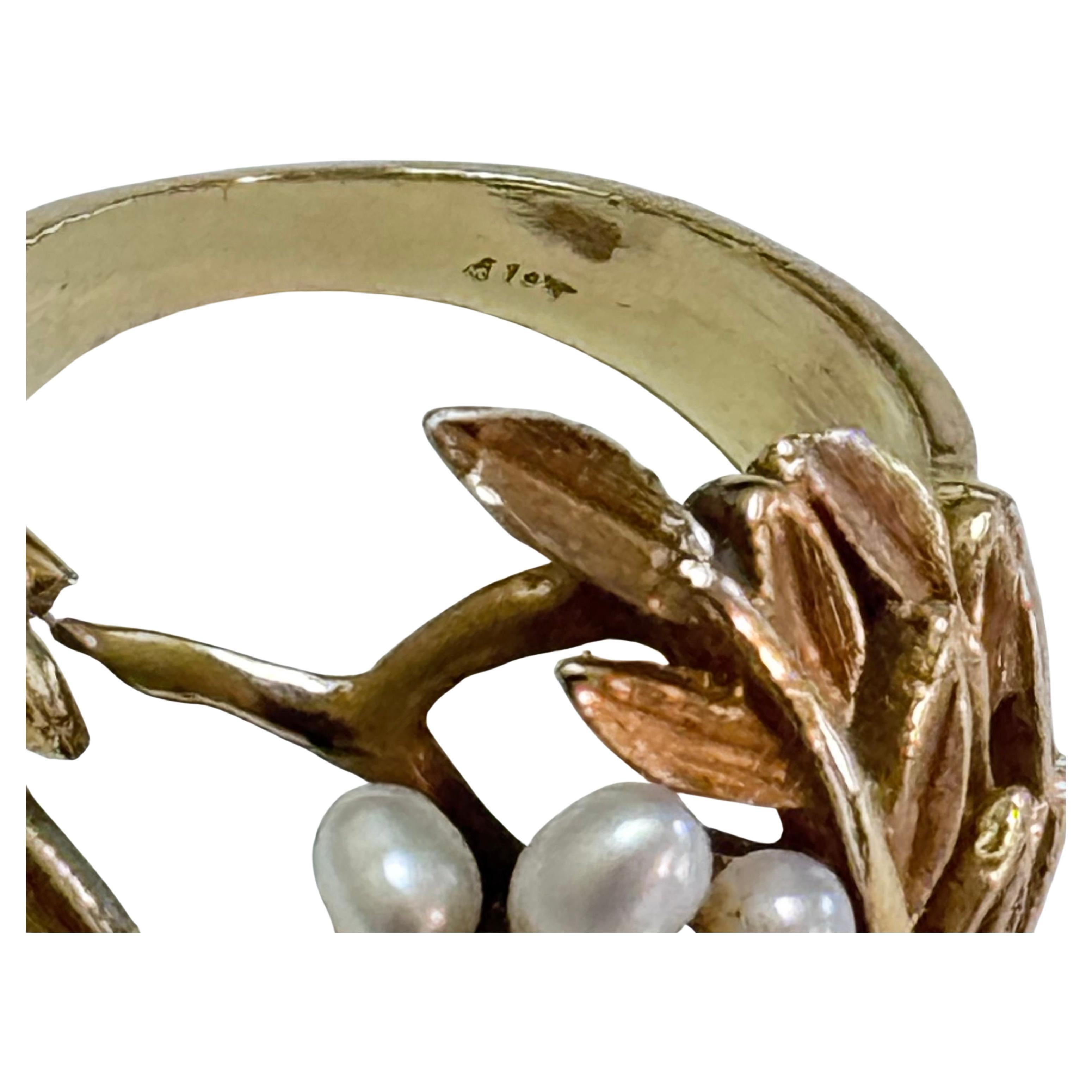 Impressive 1950's retro 14K Yellow Gold Cocktail Ring. Ring has Leaf Motif and Seed Pearls with Three Accent Diamonds. Size 8.0. Front of ring is 1 in in height. 2gms Total Weight. Ring is marked 14K.