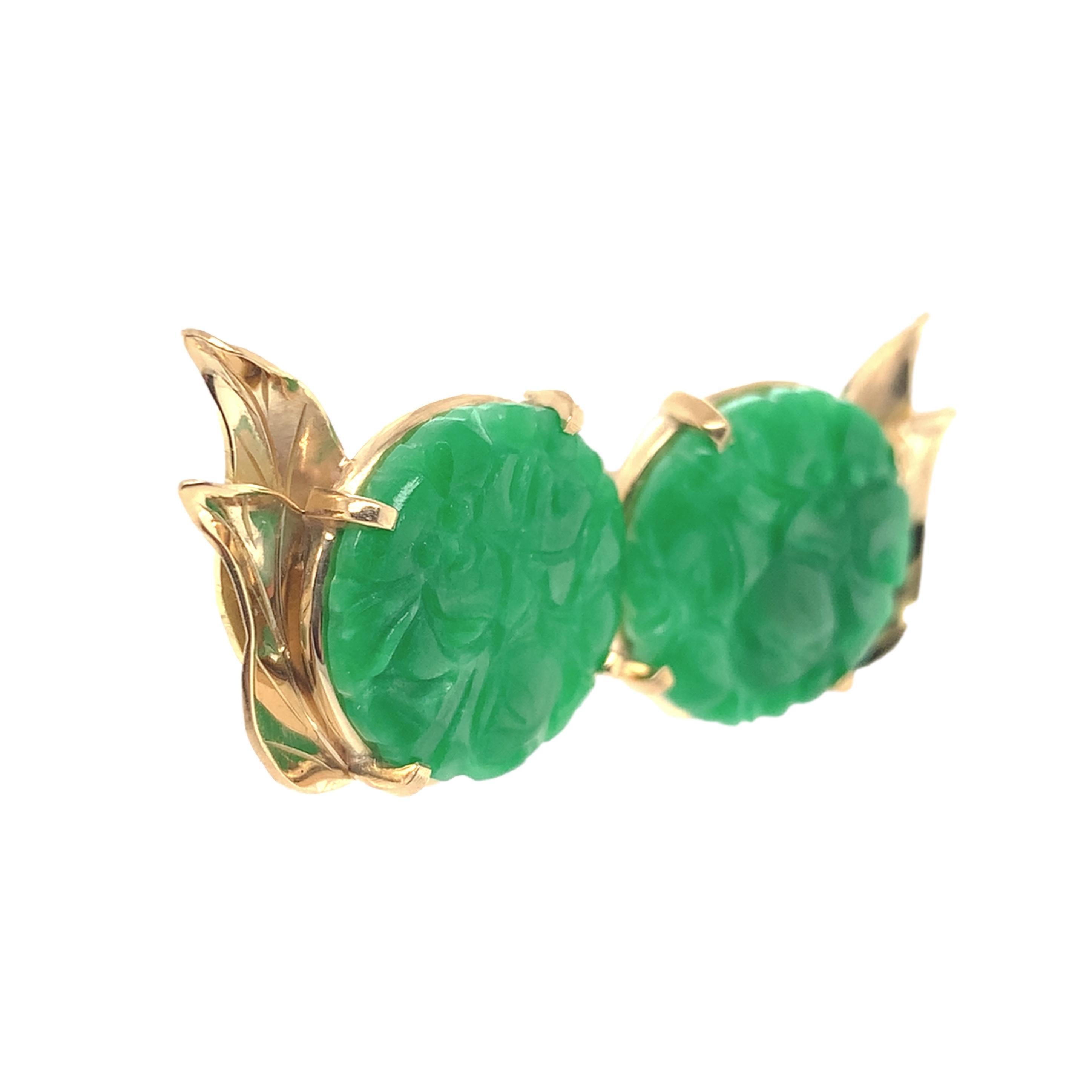 A pair of 14K yellow gold earrings with carved green jade. The earrings have a GIA report #2231536778 stating natural A jadeite jade, no indication of dye. The jade measures about 15mm and are bright green color. They have carved flowers and 2 gold