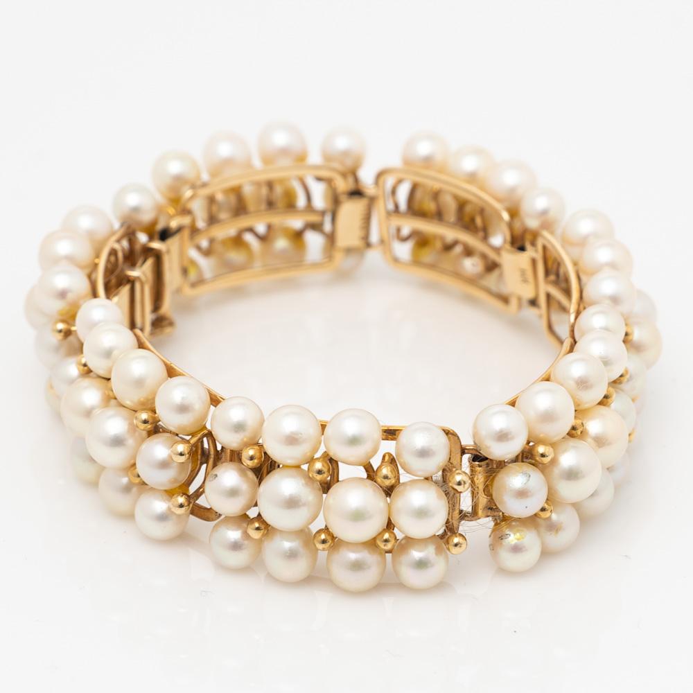 Here is a lovely estate 14k Yellow Gold Mings Hawaii Cultured Pearl Bracelet.

This bracelet features 84 cultured pearls measuring from 5.50mm to 6.50mm (in diameter). Pearls have light cream body colour with very slight greenish to rose overtones,