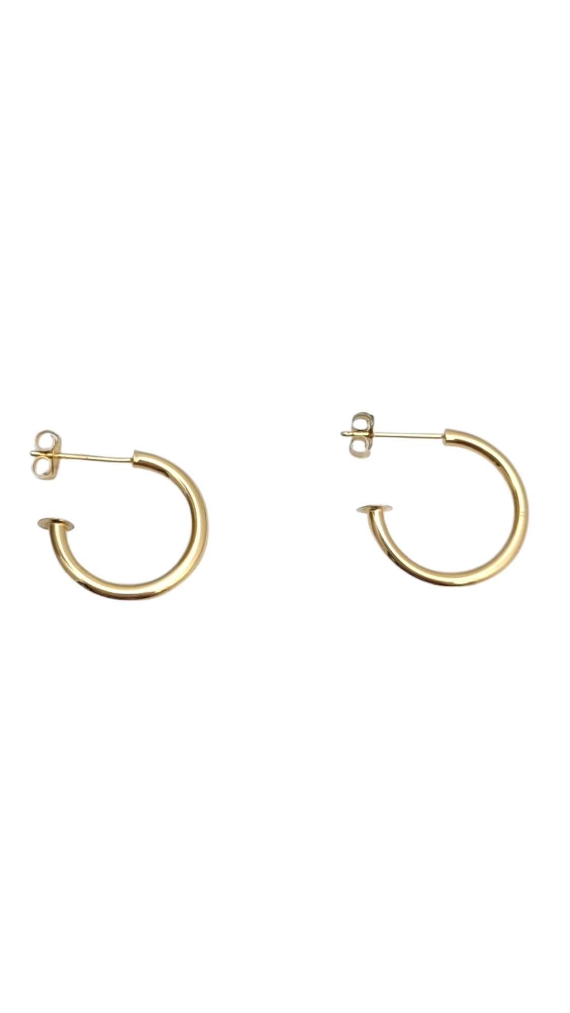 14K Yellow Gold Mini Hoop Earrings-

Delicate and stylish, these 14k yellow gold mini hoop earrings offer a subtle shine perfect for everyday wear. Their compact size makes them ideal for layering or wearing solo for a minimalist, polished