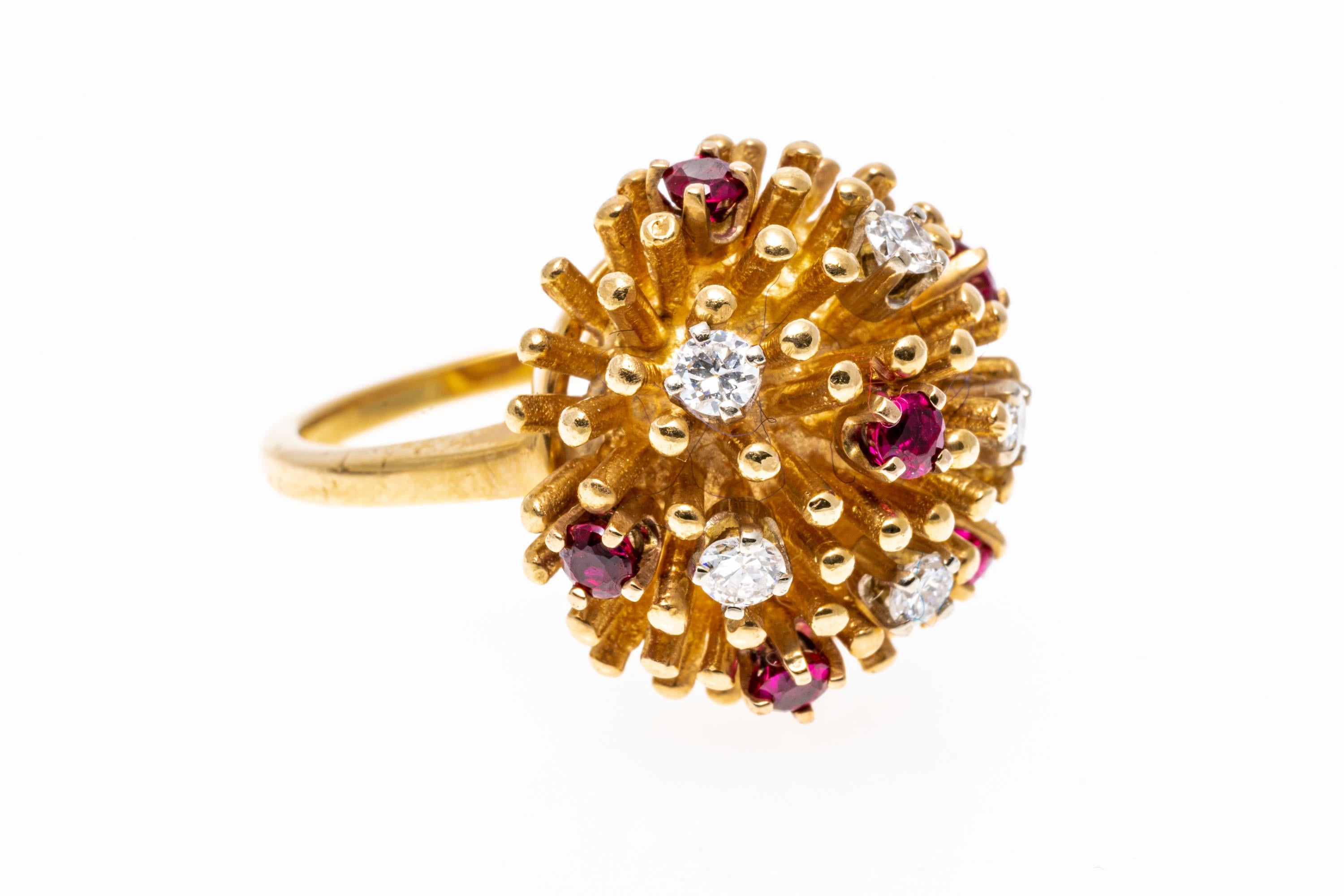 14k yellow gold ring. This fabulous round mini anemone style ring is set with yellow gold spines, decorated with scattered round faceted, pinkish red color rubies, approximately 0.30 TCW and round faceted diamonds, approximately 0.15 TCW, and prong
