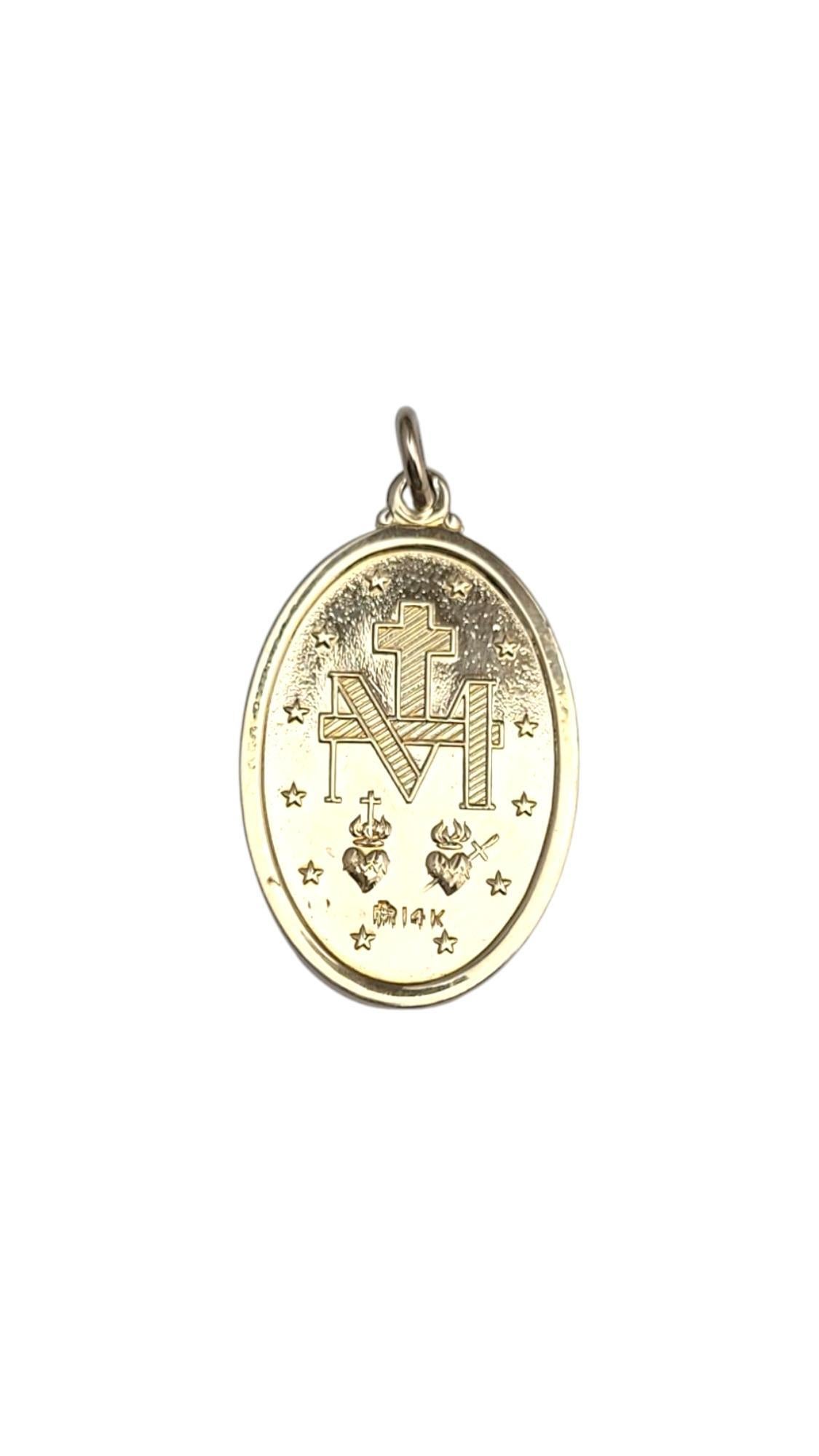 14K Yellow Gold Miraculous Medal Pendant

This meticulously detailed pendant features the Roman Catholic depiction of the Virgin Mary with an inscription of the Miraculous Medal message in 14K yellow gold. Carry a blessing with you wherever you go