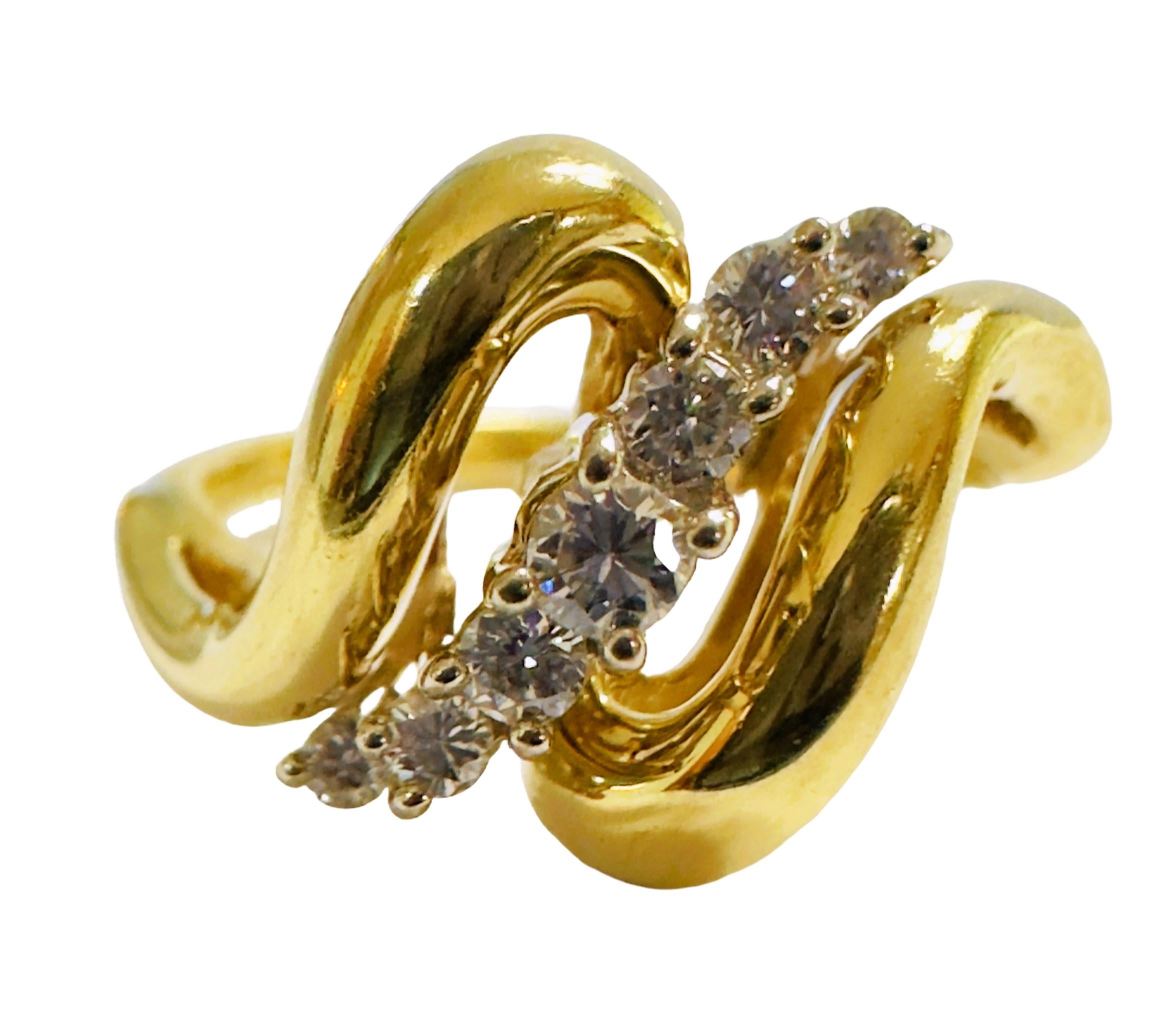 What a great design this ring has.  It has 2 swirls of 14k yellow gold surrounding 9 brilliant cut diamonds. The ring is a size 8 and is sizable and can be done by your local jeweler.  I do not resize the rings..  There is one diamond measuring 2.7