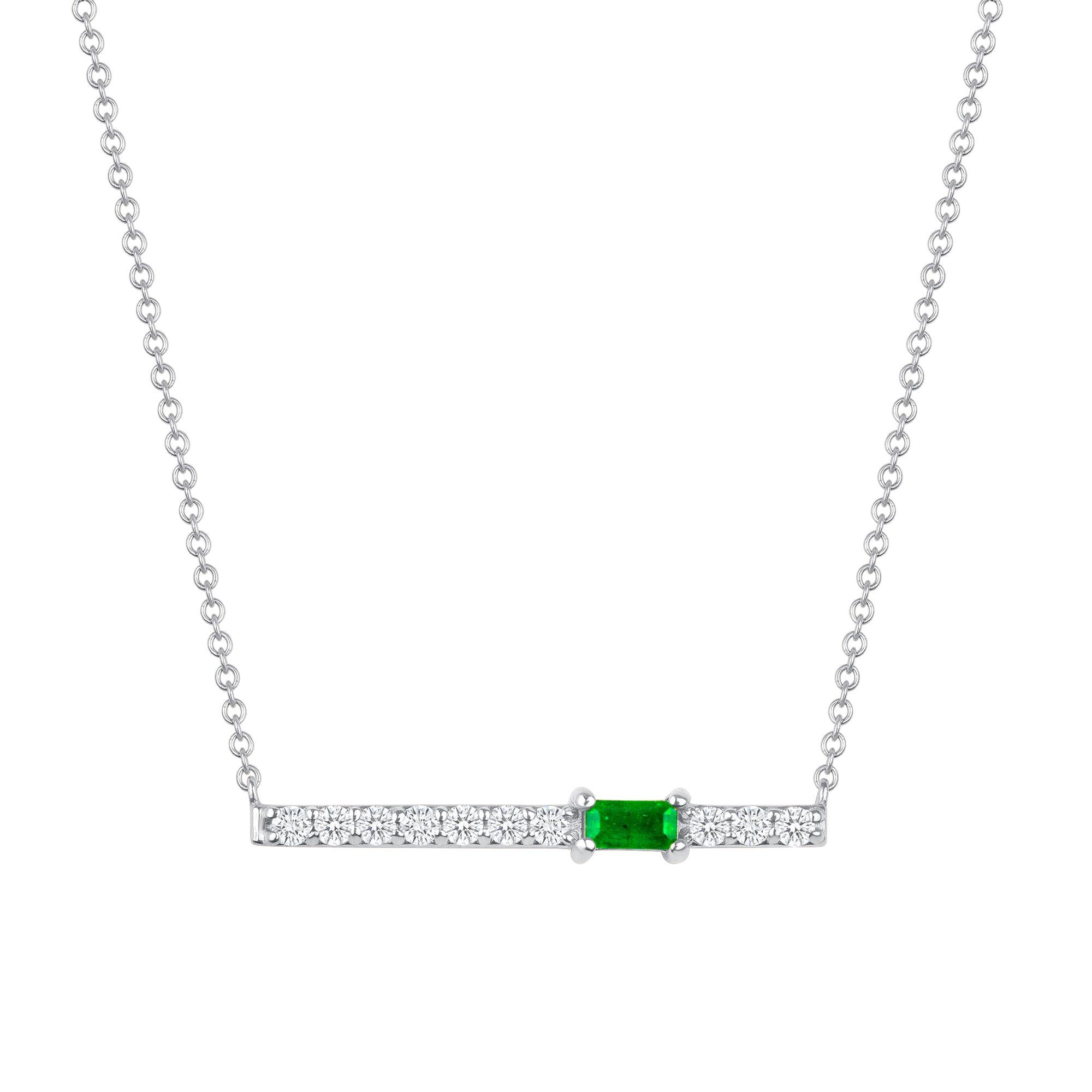 Crafted in 14K gold, round glistening diamonds enclose a baguette emerald stone on this contemporary bar pendant. This stunning necklace is a modern piece that sits elegantly above the collarbone making it the perfect necklace for layering or just