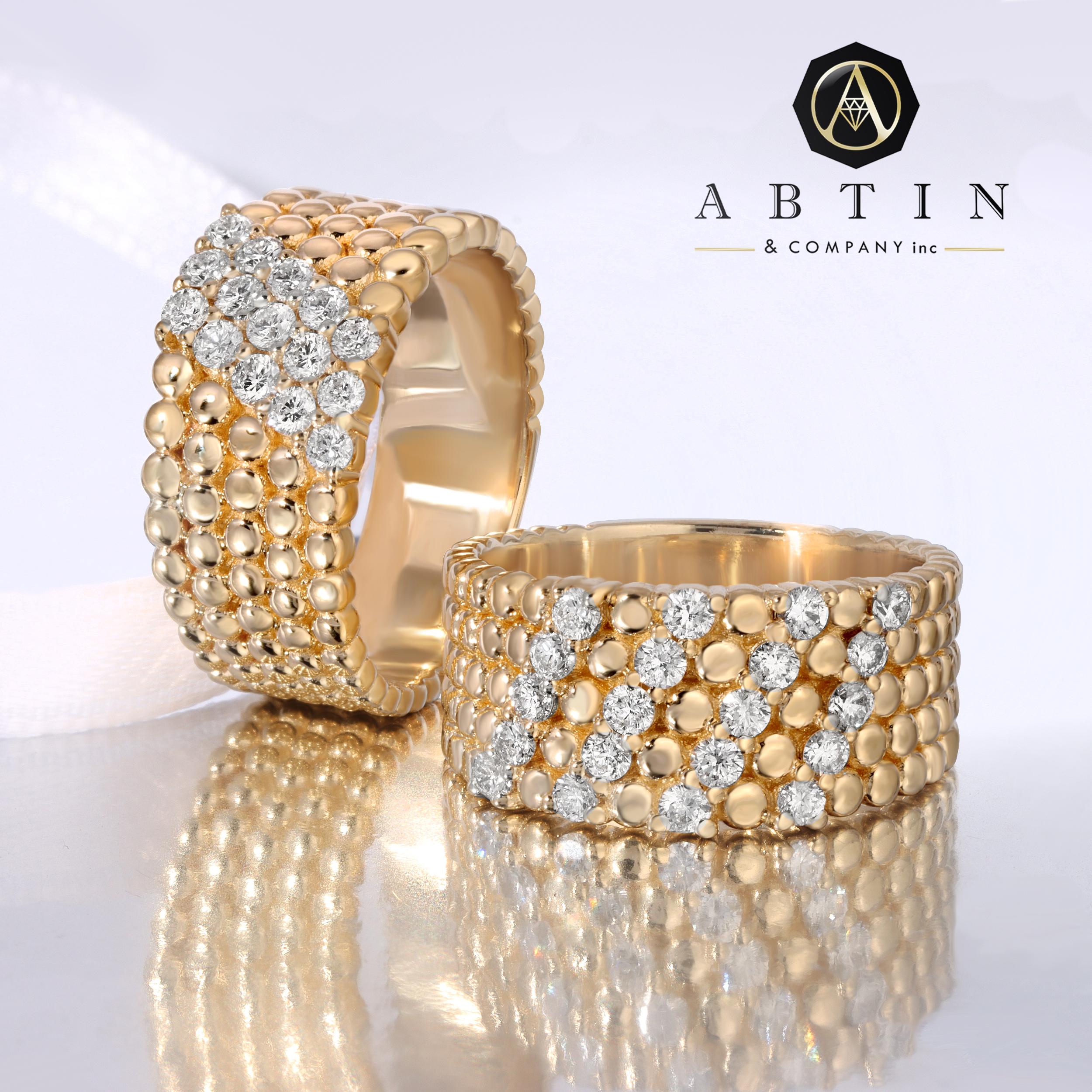 Fabriquée en or 14k, cette bague contemporaine en or jaune avec des détails perlés et des diamants est un choix idéal pour une utilisation quotidienne. Les trois rangées de diamants ronds sertis dans les anneaux perlés ajoutent une touche de