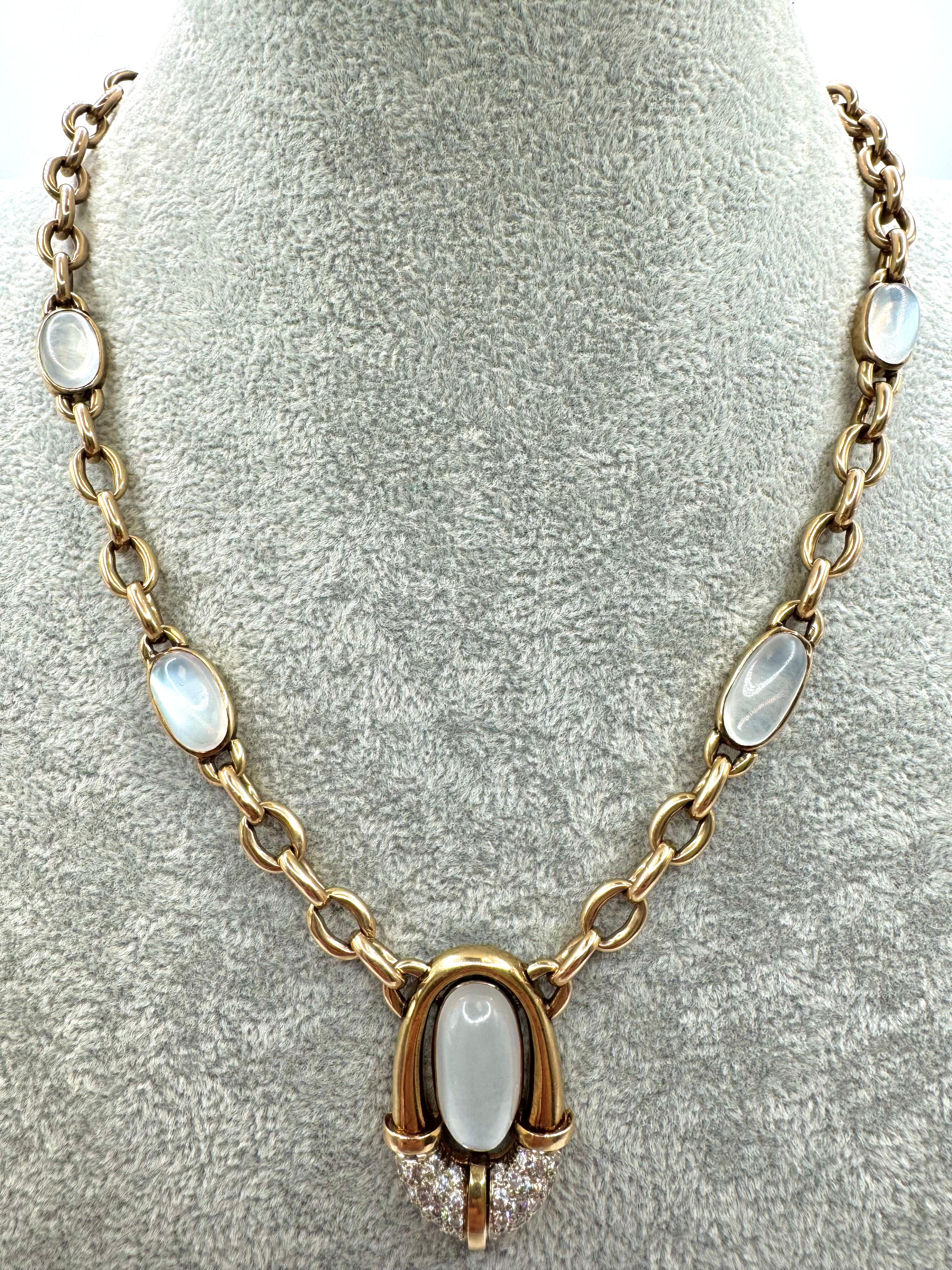 Questa straordinaria collana presenta una serie di cabochon di pietra di luna luminosi incastonati in un ricco oro giallo a 14 carati. Il pendente centrale mostra una grande pietra di luna ovale incorniciata in un design a ferro di cavallo in oro,