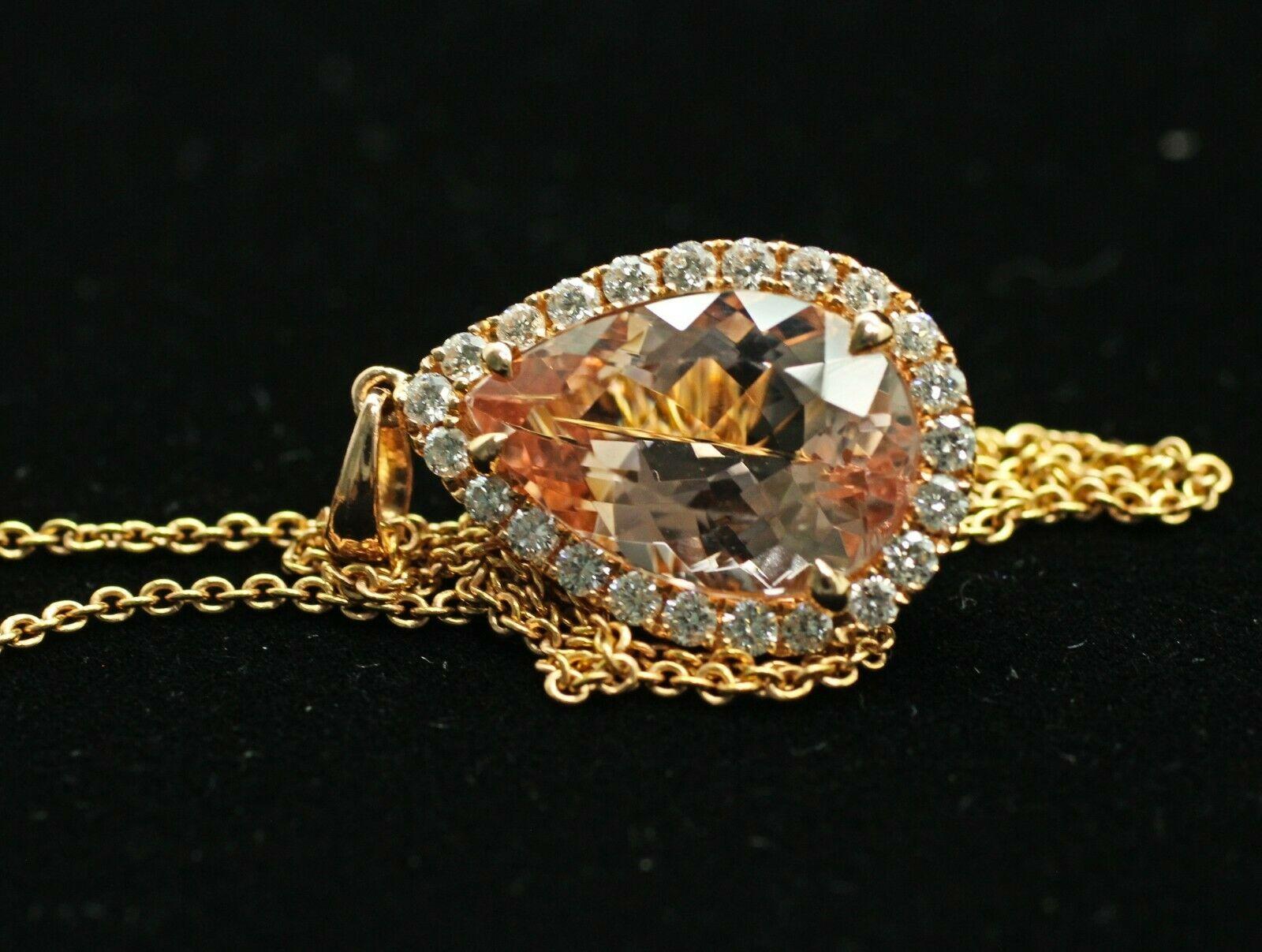  Surprise a special woman in your life with this large, breathtaking, statement halo morganite diamond necklace.This eye-catching pendant necklace features 0.46ct total weight of accent diamonds surrounding a 14.9mm-9.9mm pear cut Morganite, all set