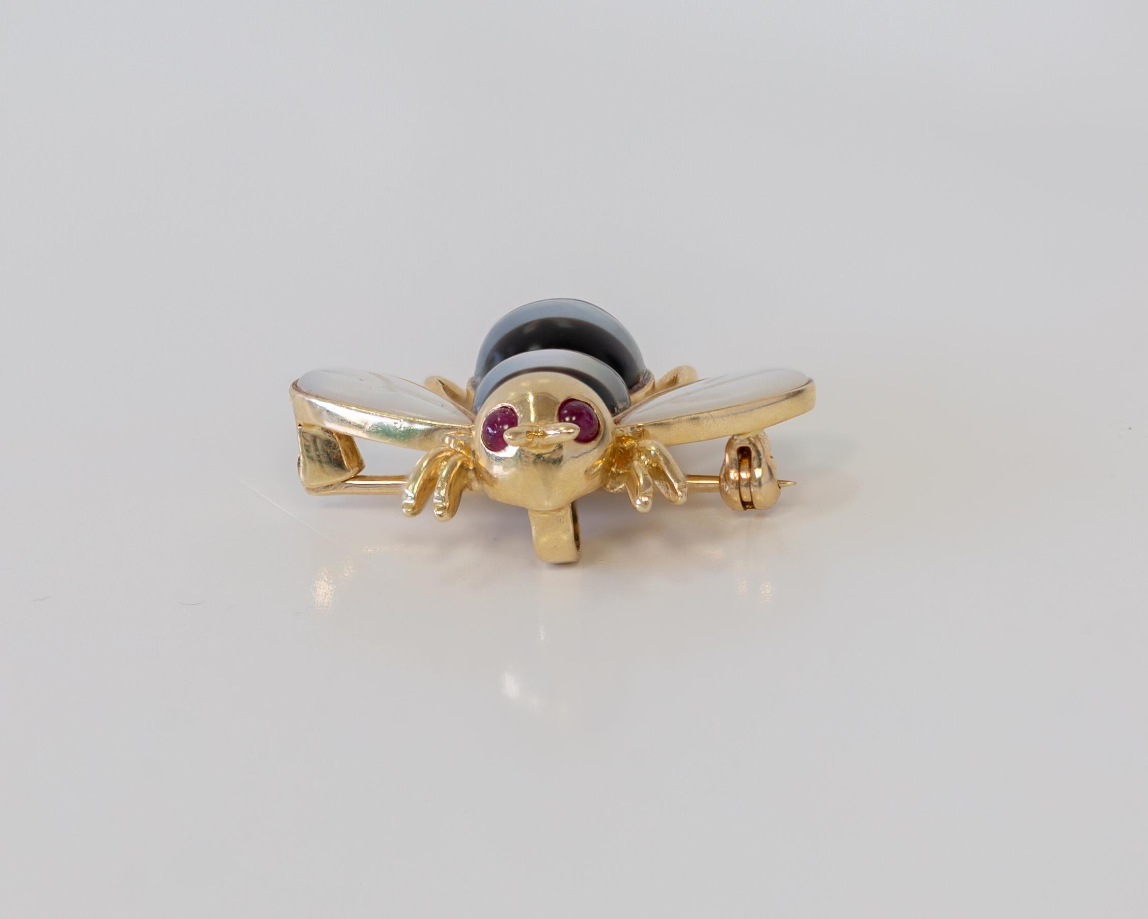 Basic Info 
NB00045
14K Yellow Gold 
Bee Brooch with Black & White Mother of Pearl Stones for Body & Rubies for Eyes 
Brooch Weight 5.1 Grams