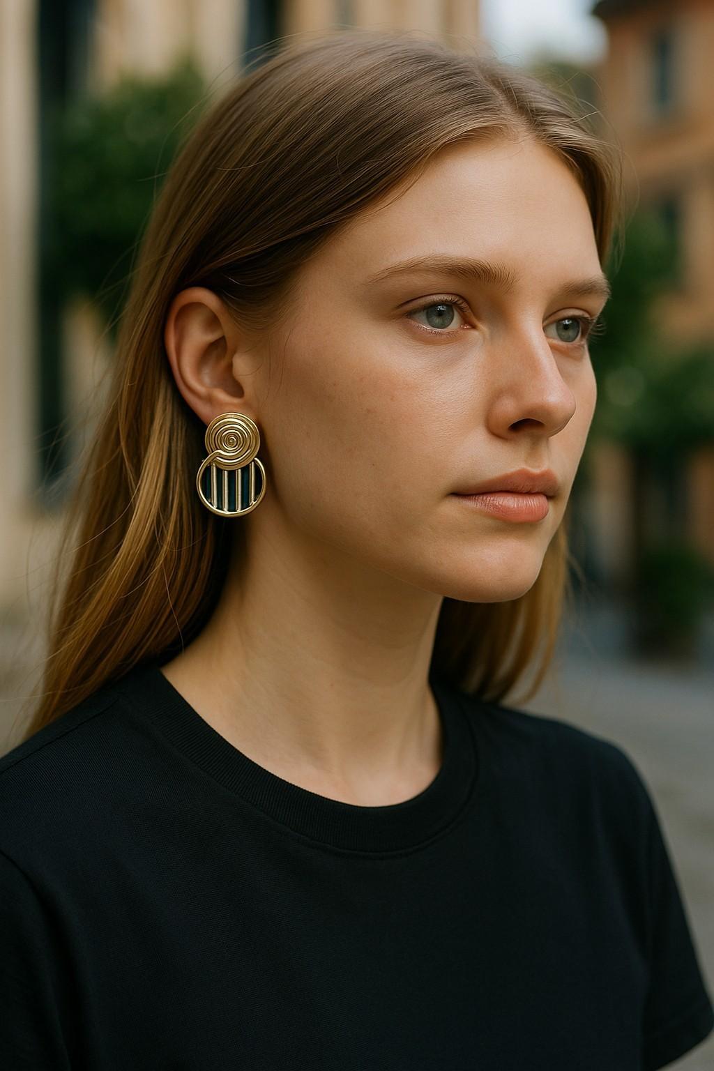 An Elegant Symphony of Color and Textural Contrast

Add a dash of timeless charm to your collection with these 14K Yellow Gold Vintage Stud Earrings, featuring a harmonious blend of gray mother-of-pearl, black onyx, and sodalite. Each stone’s