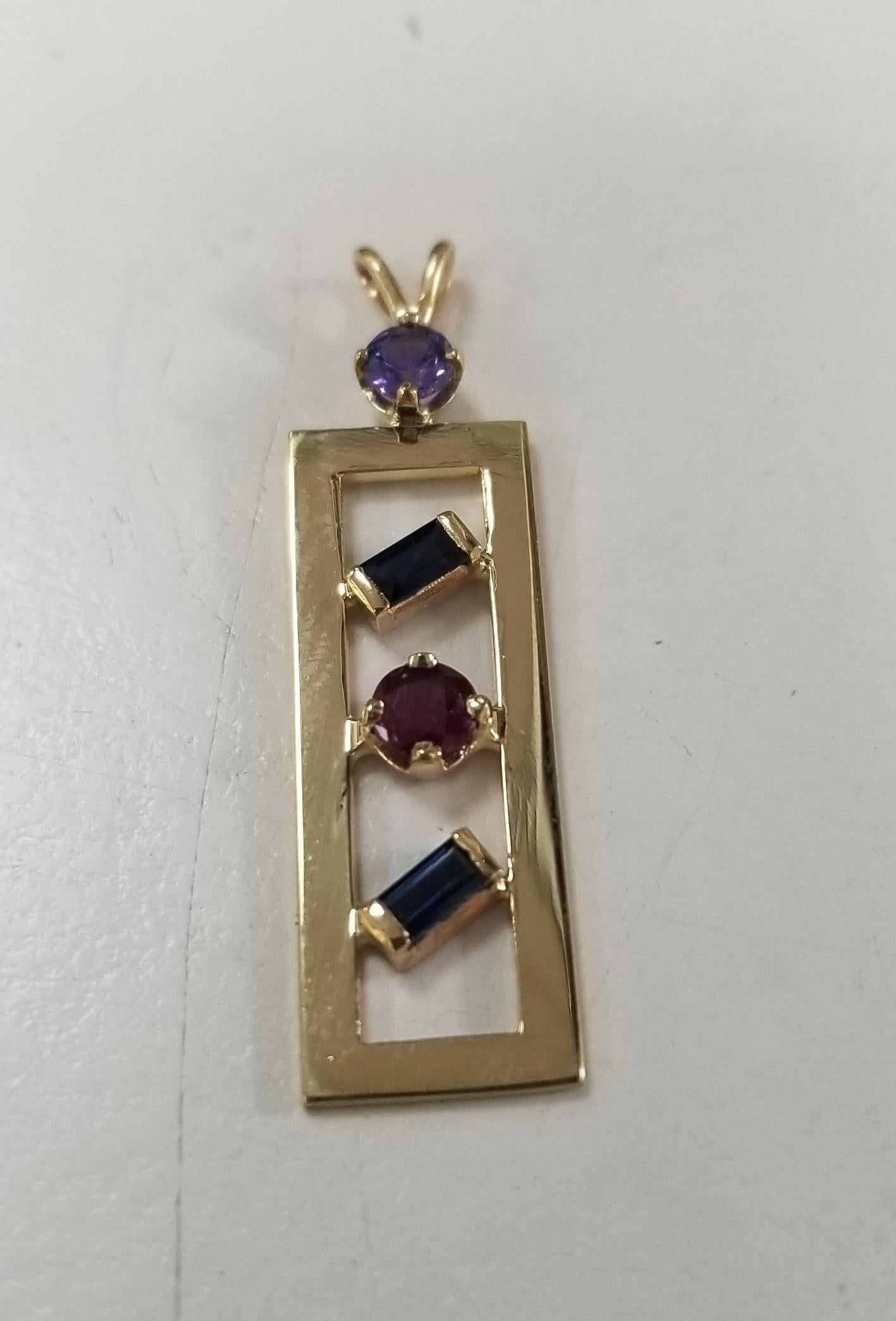 14k yellow gold multi color gemstone pendant, with sapphires, ruby and amethyst.  no chain