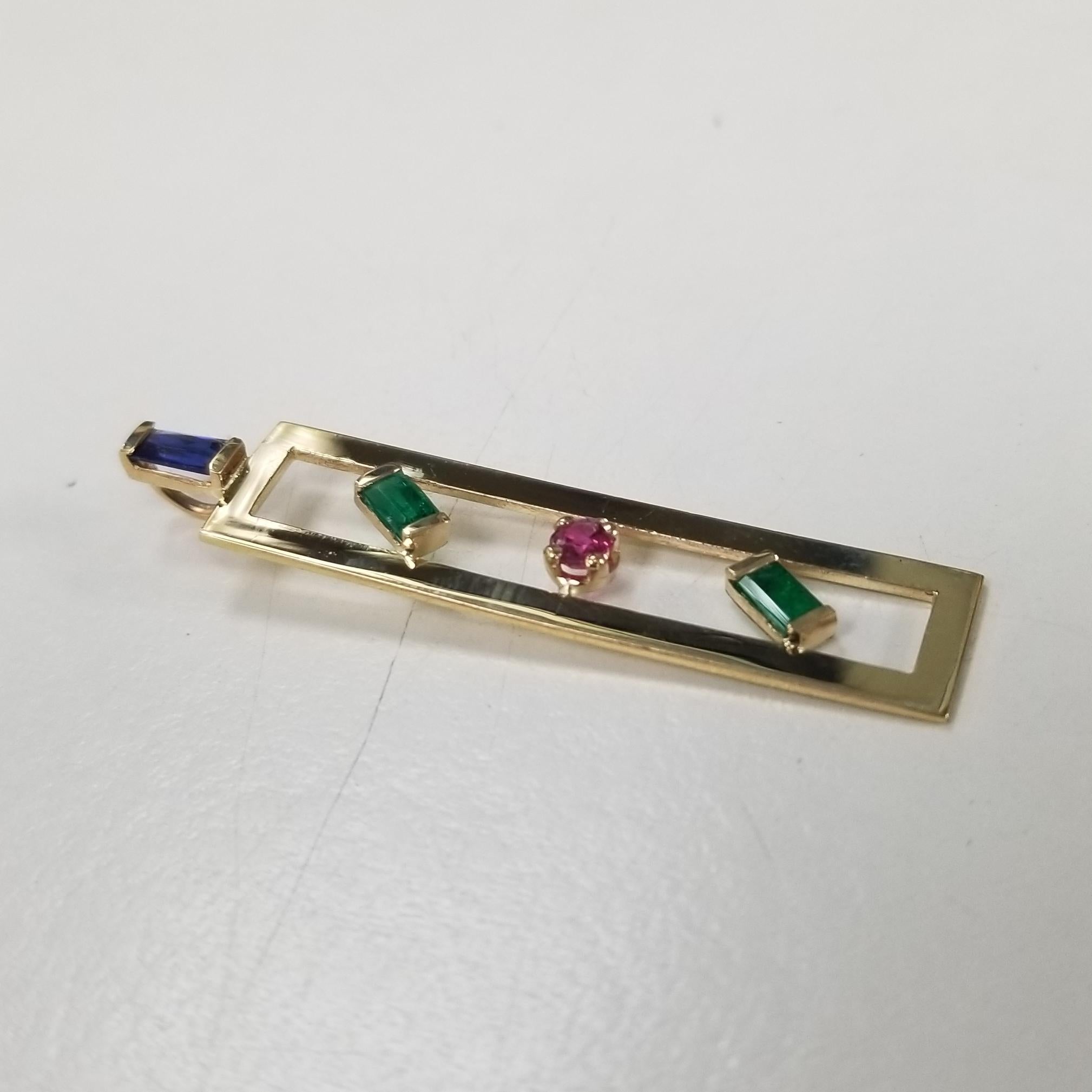 14k yellow gold multi color gemstone pendant, with sapphires, ruby and emerald.  no chain