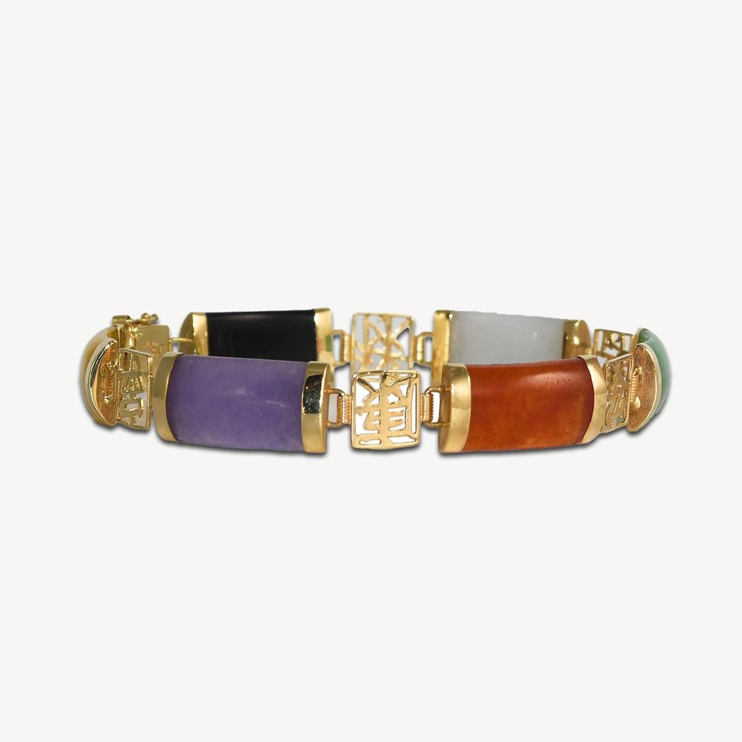 Ladies' 14k yellow gold and multi-color jade bracelet.
The clasp is stamped 585 14k  and the bracelet weighs 10.3 grams gross weight.
There are six jade sections of different colors.
Excellent color qualities.
The bracelet measures 7 inches long and