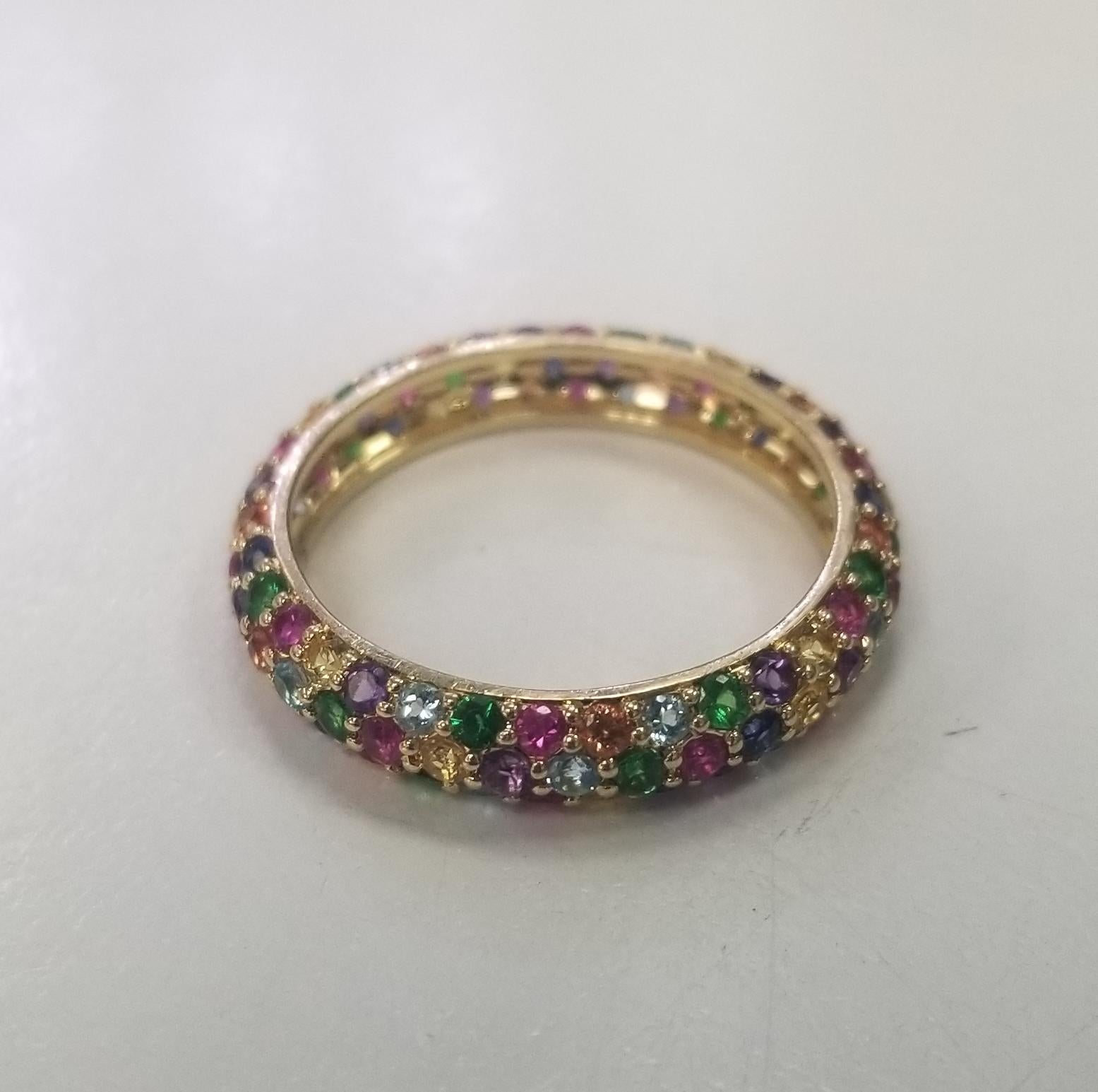 Specifications:
    main stone: round cut Multi colored Gem stones 104 PCS
    carat total weight: APPROX. 2.50 CARAT TOTAL WEIGHT 
    brand: NONE
    metal: 14K GOLD
    type: ETERNITY ring
    weight: 3.0 GrS
    size: 9 US



