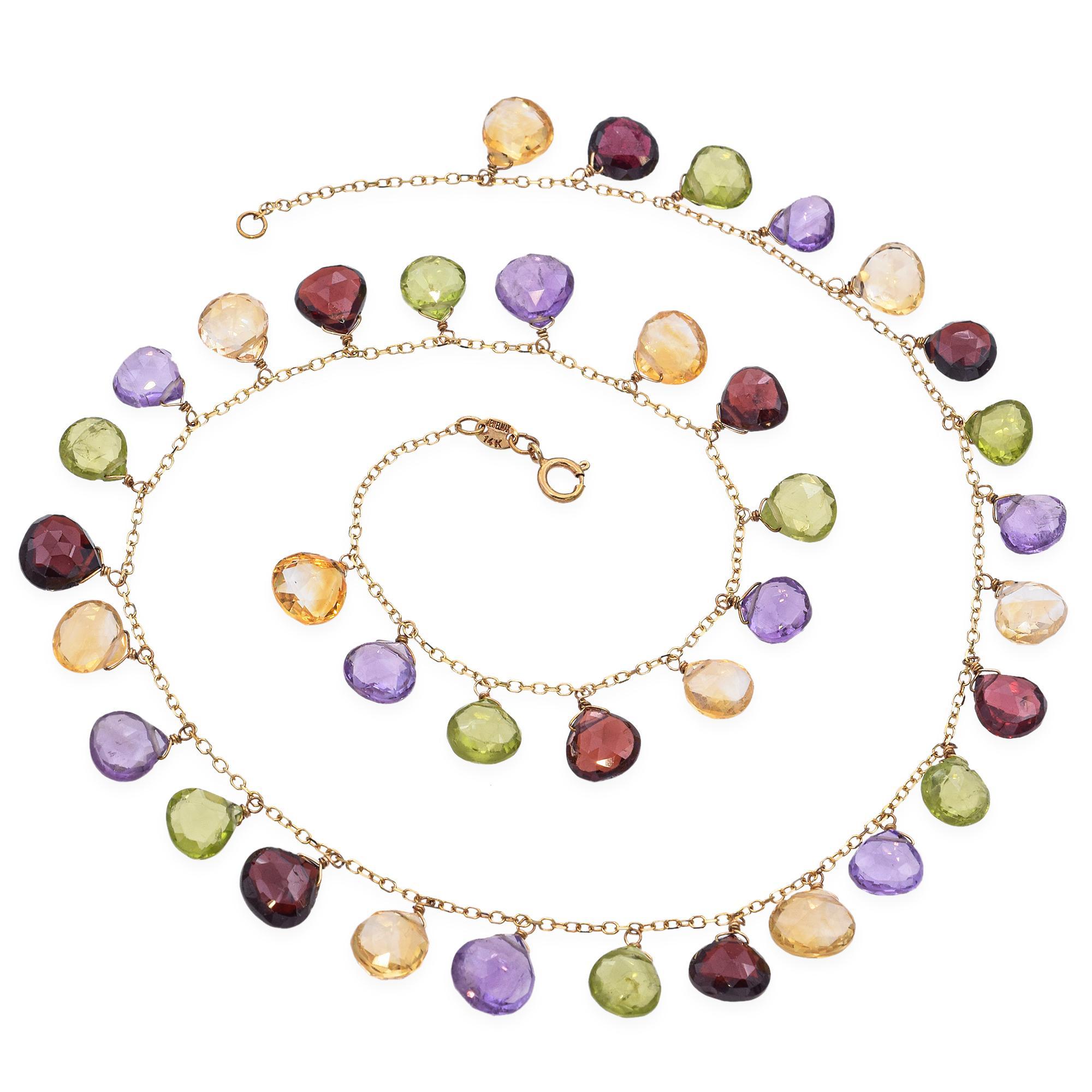 Questa collana vintage in oro giallo 14K mette in mostra un vivace mix di gemme semi-preziose dal taglio briolette, tra cui ametista, peridoto, citrino e granato. Con un peso di 13,6 grammi e una lunghezza di 15 pollici, presenta pietre
