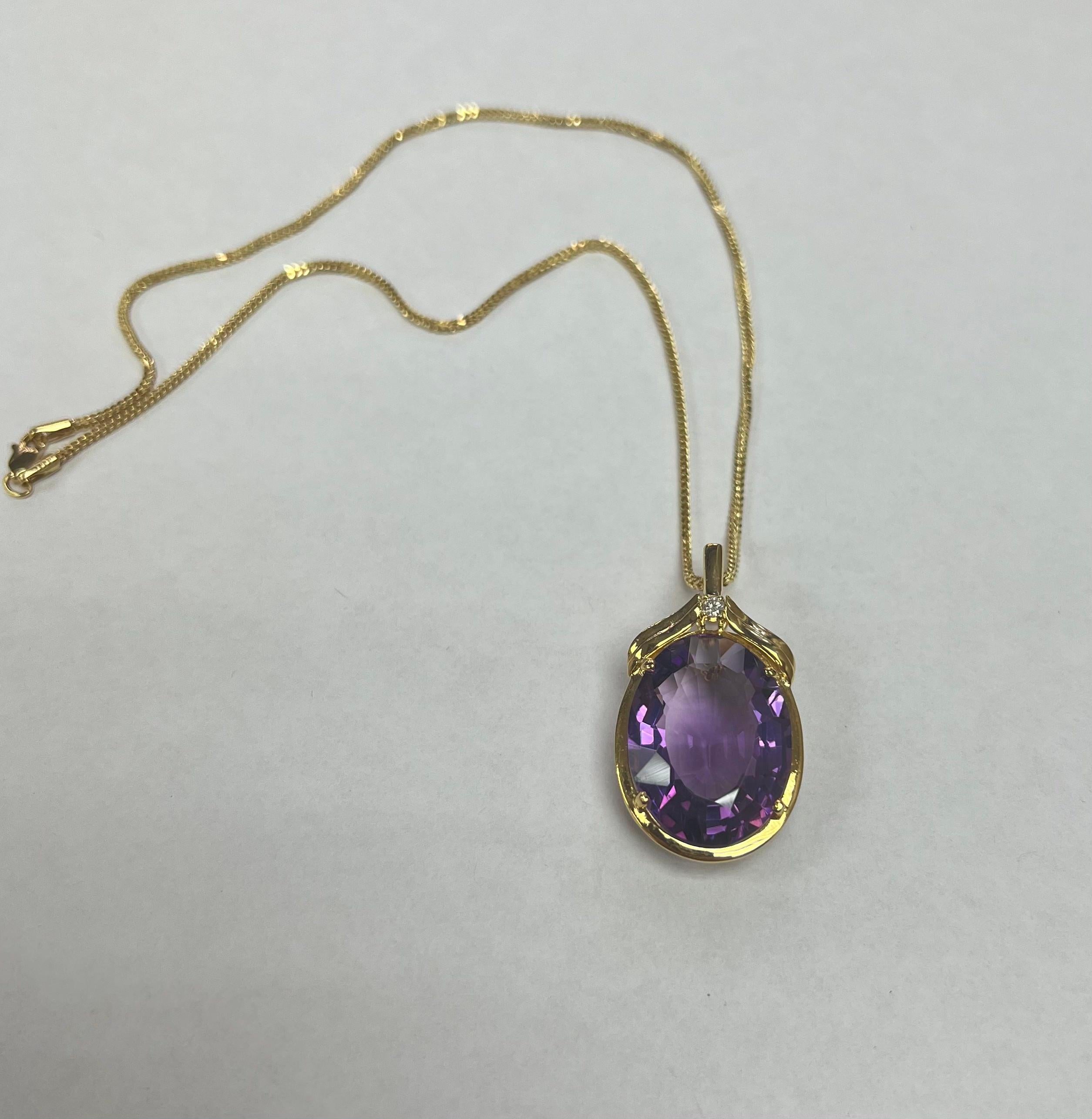 Showcasing a stunning and vibrant Amethyst Necklace. The pendant offers a perfectly set center Oval Shape Amethyst,  suspended from a beautiful 22 inch chain, all in Yellow Gold. The beautiful center stone is an all natural Amethyst weighing 15.01