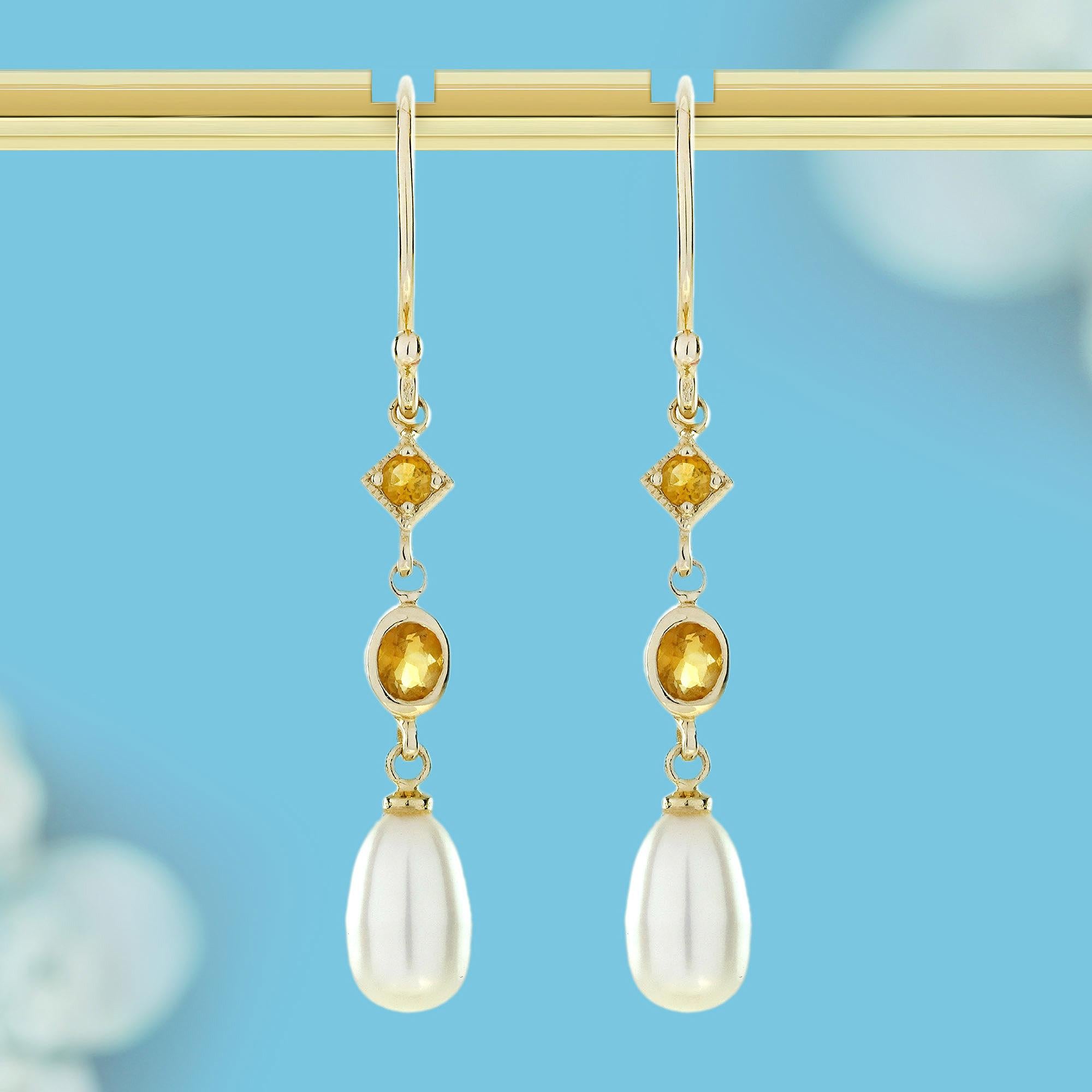 These Natural Citrine and Pearl Vintage-Style Dangle Earrings combine warmth and elegance in a timeless design. A golden citrine gemstone takes center stage, beautifully decorated with vintage detailing. Below, a luminous pearl drop adds graceful