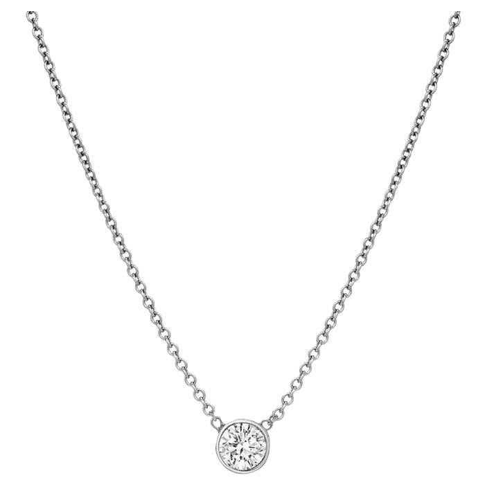 This diamond necklace features an elegant round diamond in 14k gold.

Gold: 14k
Setting: Bezel
Clasp: Lobster Claw Clasp
Color: Yellow Gold
Diamond Cut: Round
Diamond Color: F-G
Diamond Clarity: VS-SI 
Necklace Length: 16 Inch 
Carat Weight: 0.50