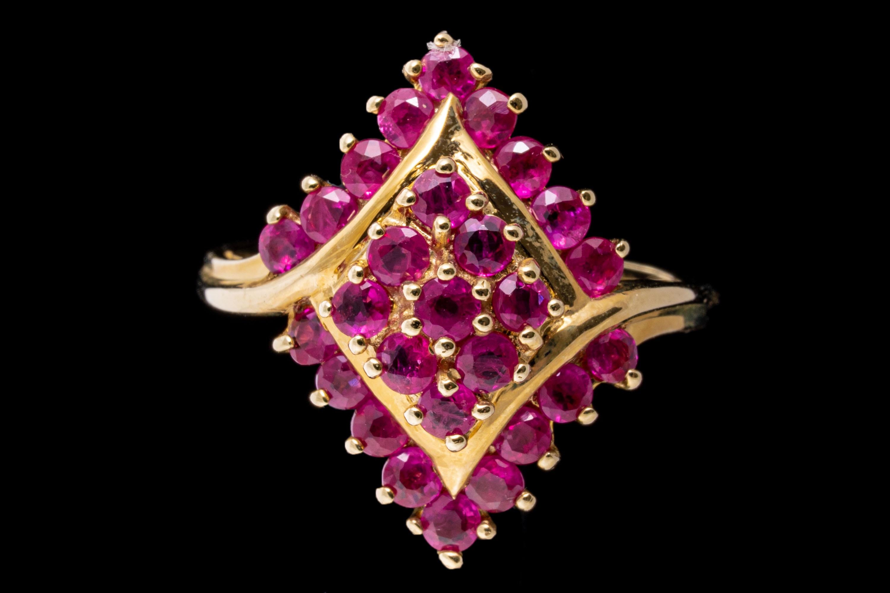 14k yellow gold ring. This lovely navette shaped bypass cluster ring is set with round faceted, pinkish red color rubies, prong set, approximately 1.39 TCW and decorated with a yellow gold embellishment.
Marks: 14k
Dimensions: 9/16