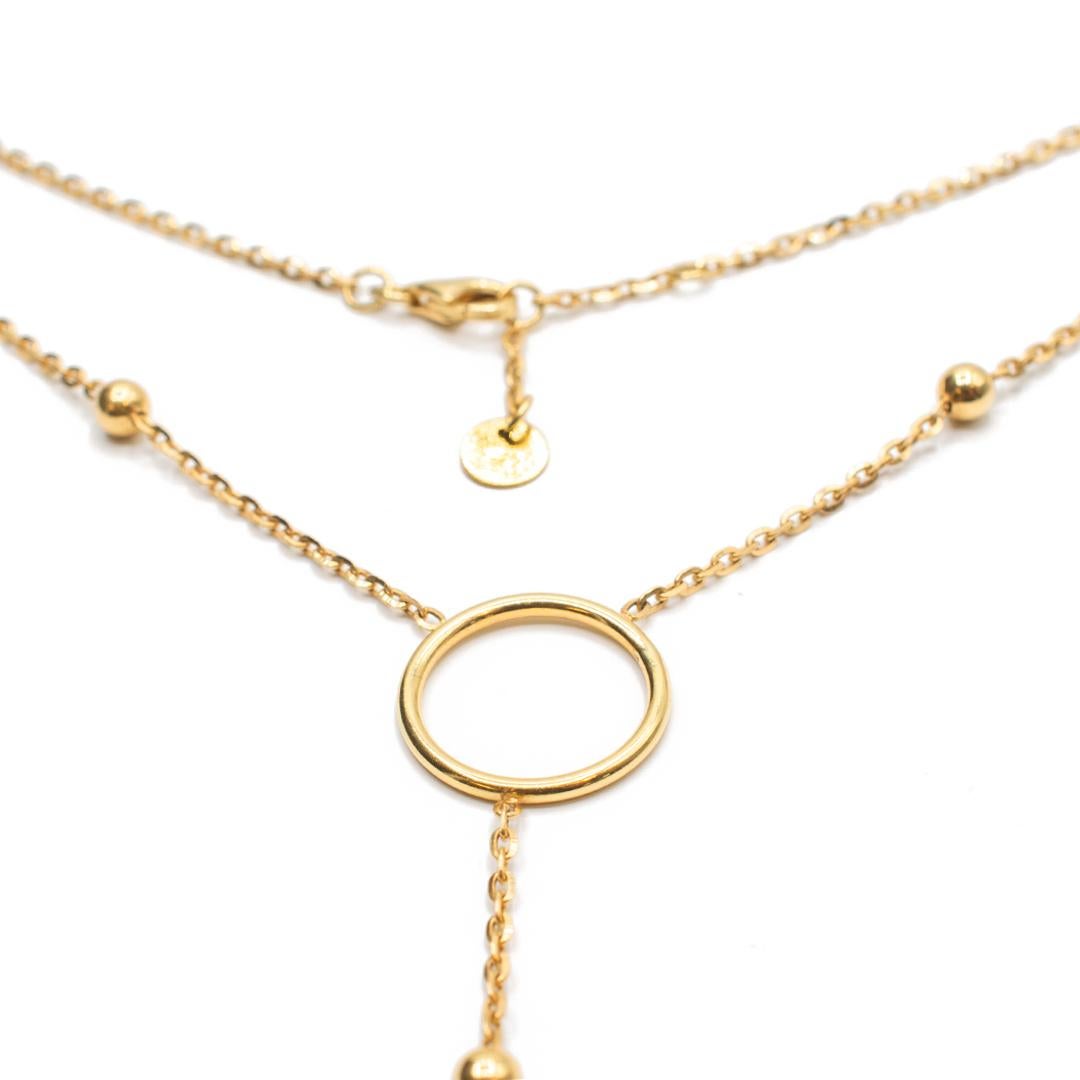 One lady's custom made, custom designed polished 14K yellow gold single strand opera, station necklace. The necklace measures approximately 16.00 inches in length and weighs a total of 6.40 grams. Engraved with 